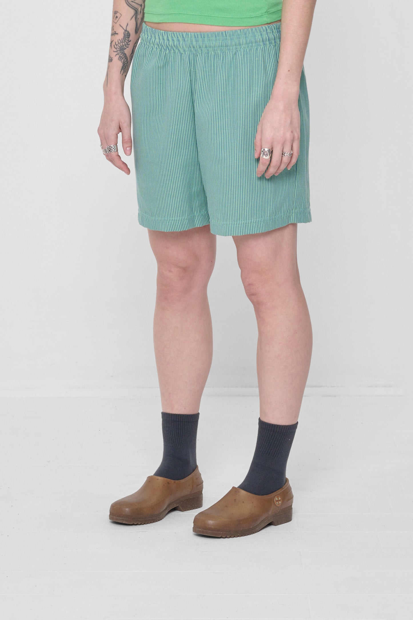 3/4 view highlights elastic waist and skinny blue and green overdye stripes.