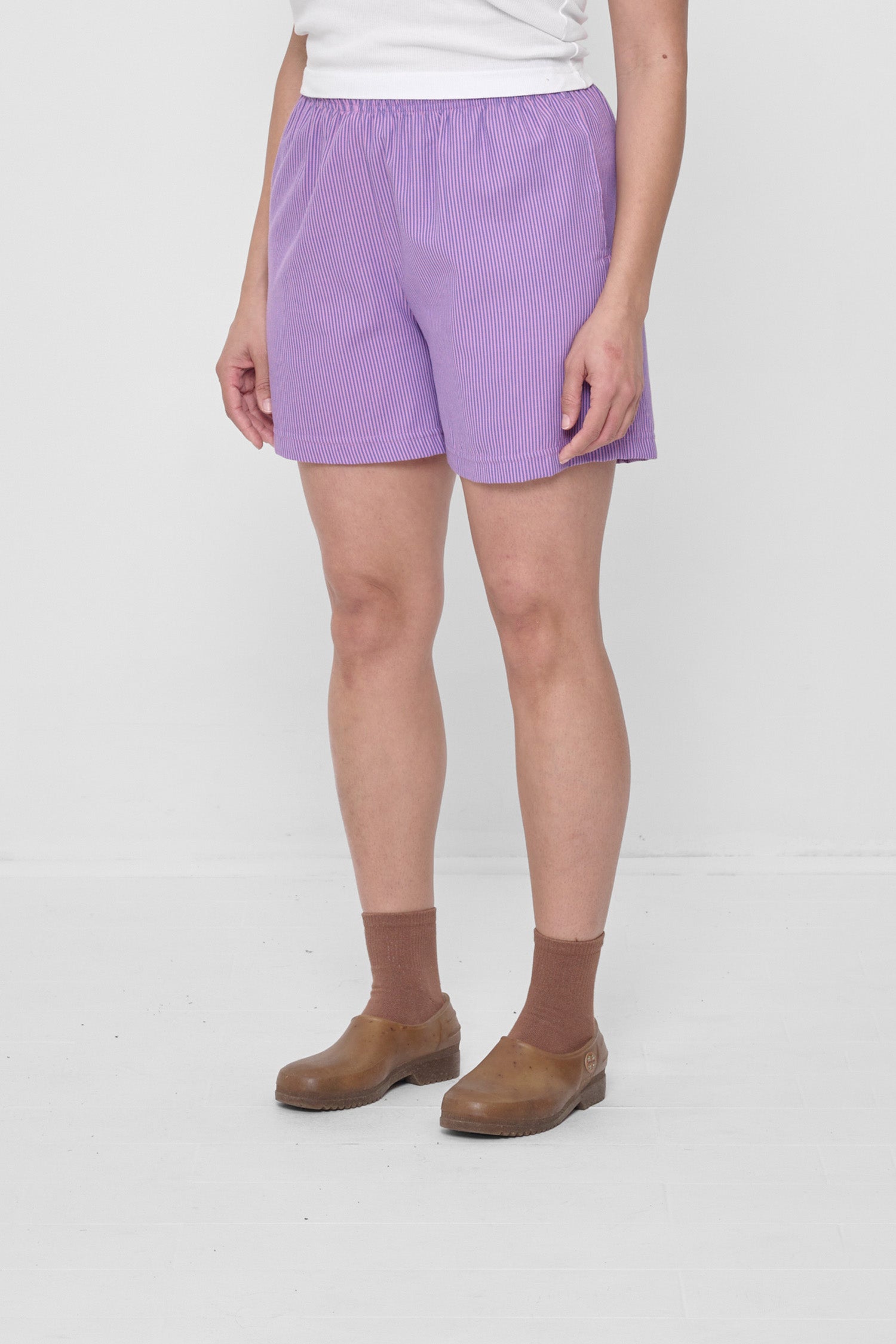 3/4 view highlights elastic waist and skinny pink and blueish purple overdye stripes.