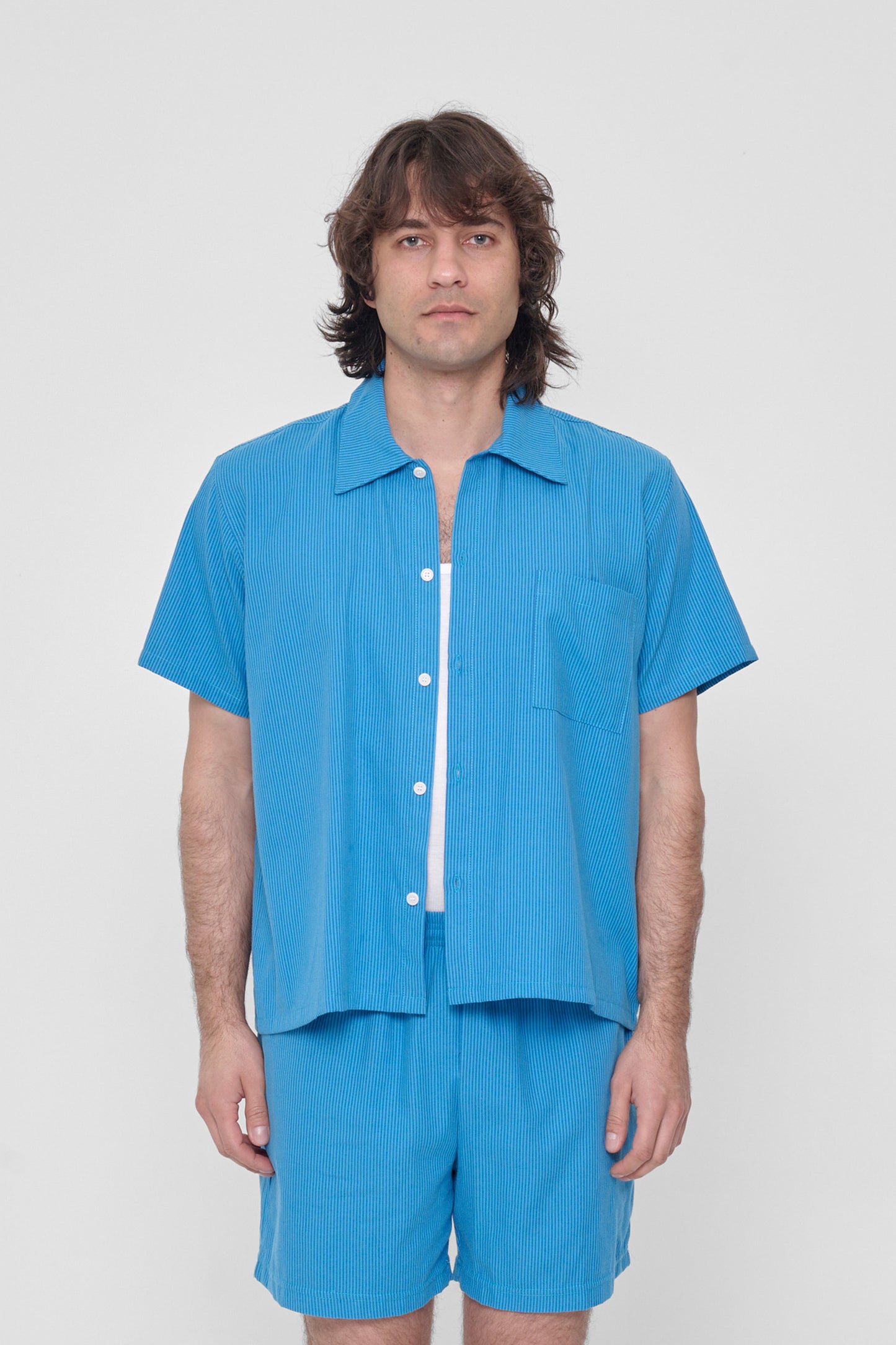 6'2" man wearing size L Malibu Stripe Short Sleeve Button-Up Shirt. Hem hits him at his hip. 