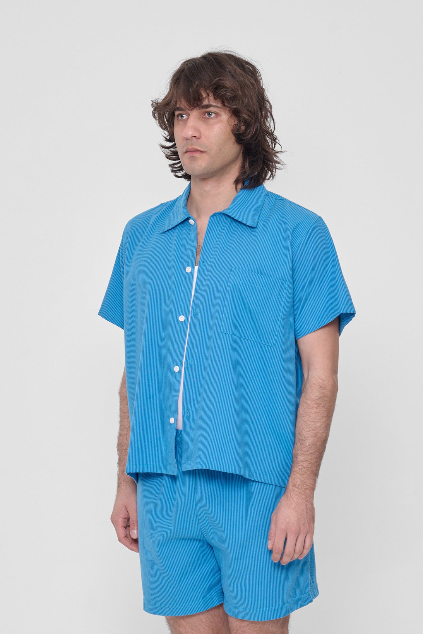 3/4 view showing structured sleeve and front pocket. 
