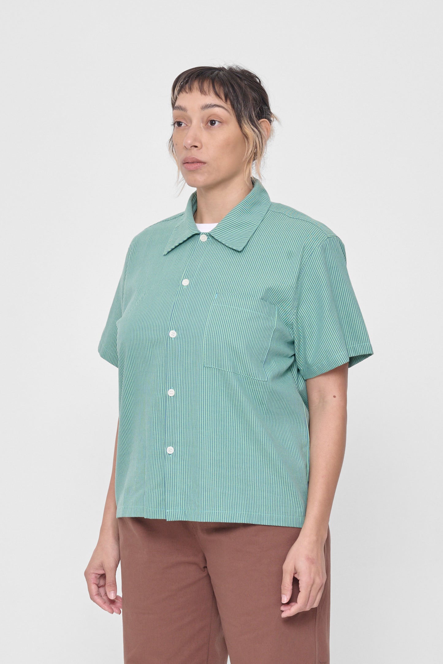 3/4 view showing structured sleeve and front pocket. 