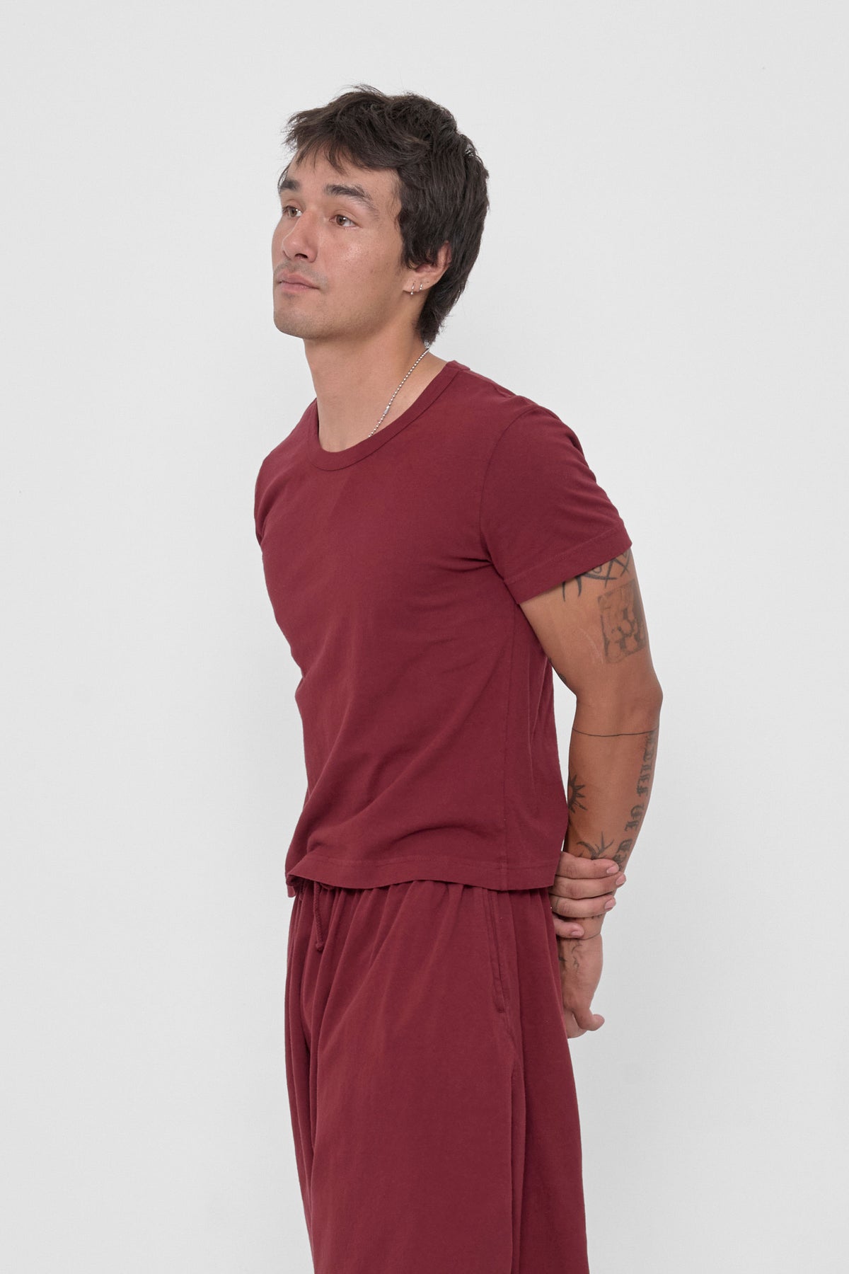 Tailored Trash Tee in Garnet – 3/4 front view on model