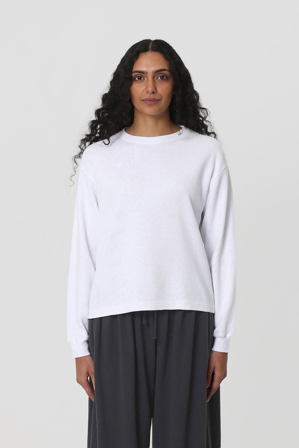5'10" woman in a size S White Thermal Long Sleeve Boxier Trash Tee. Hem hits the upper-middle hip. 