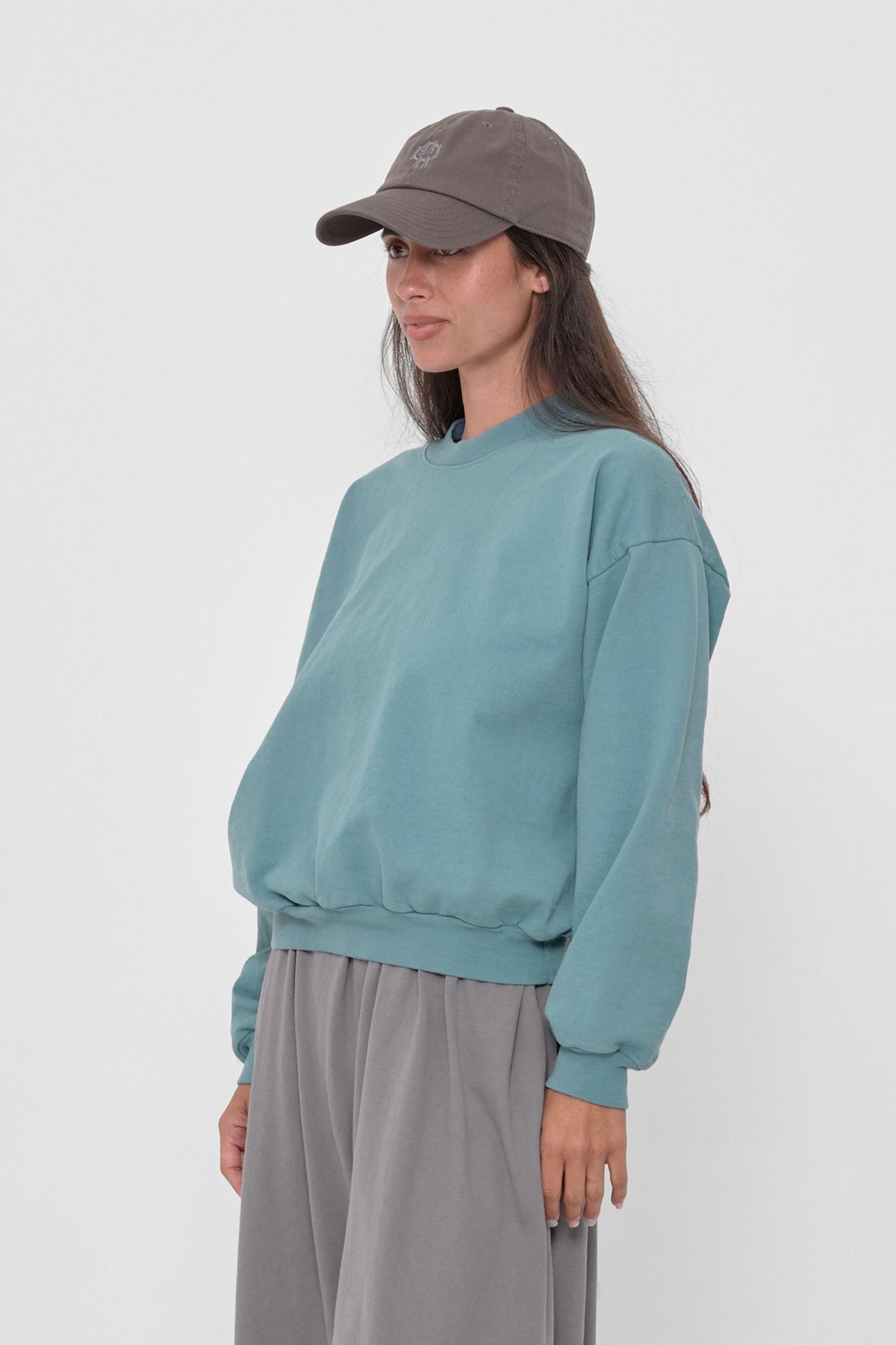 Trash Crewneck in Oyster – 3/4 front view on model