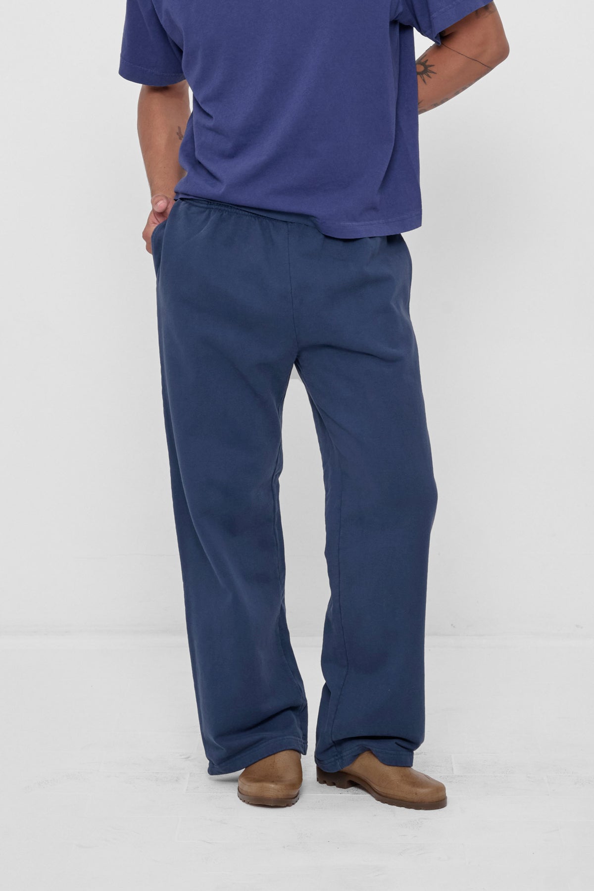Trash Fleece Apartment Pants in Washed Navy – front view on model
