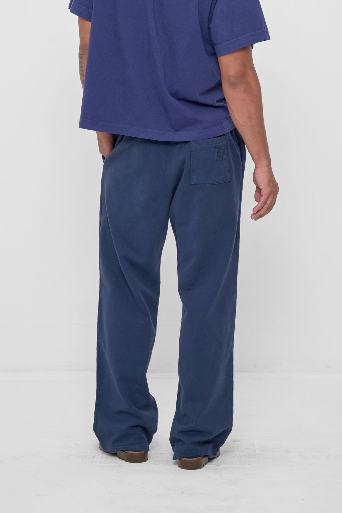 Trash Fleece Apartment Pants in Washed Navy – back view on model