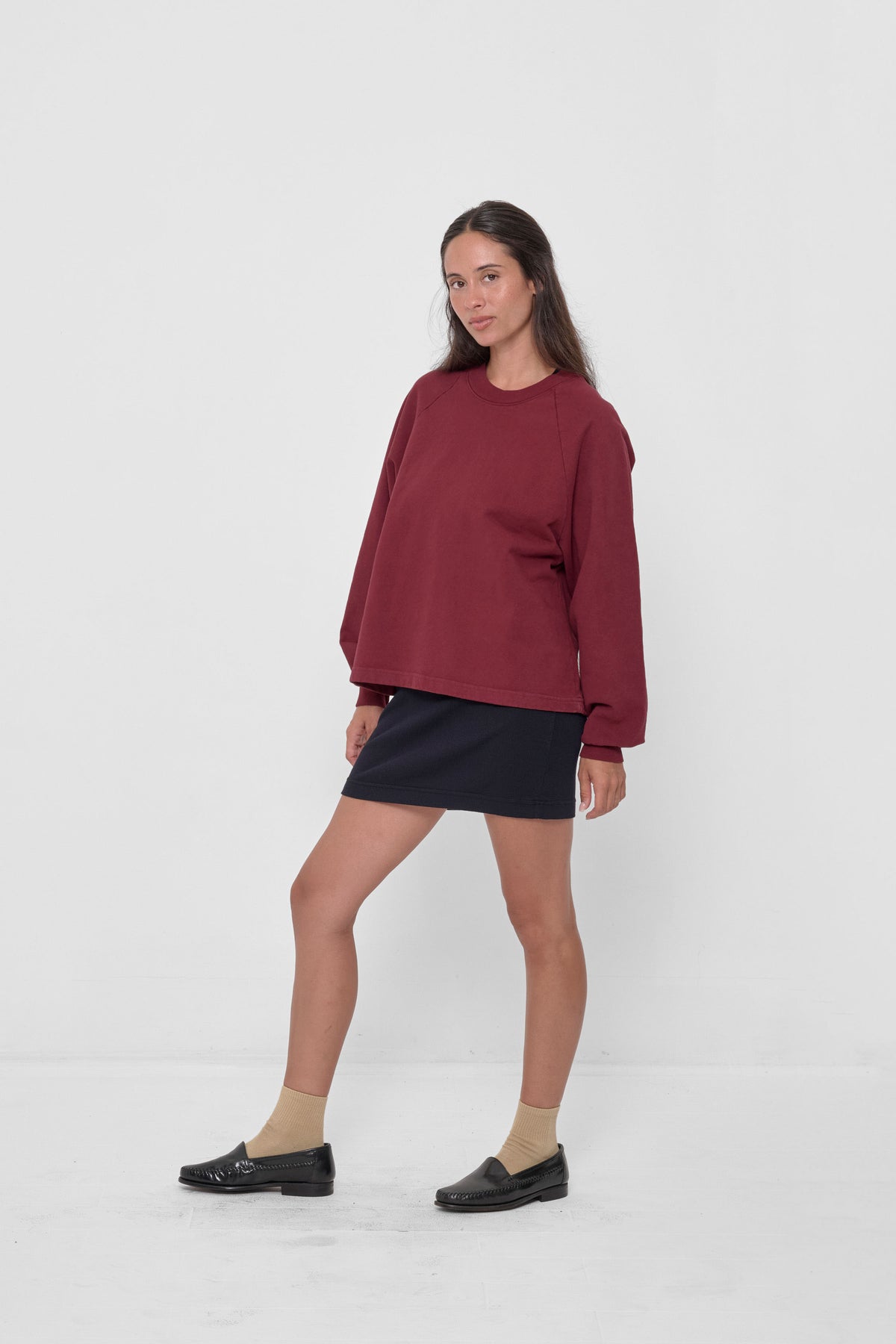 Trash Raglan in Garnet – 3/4 front view on model