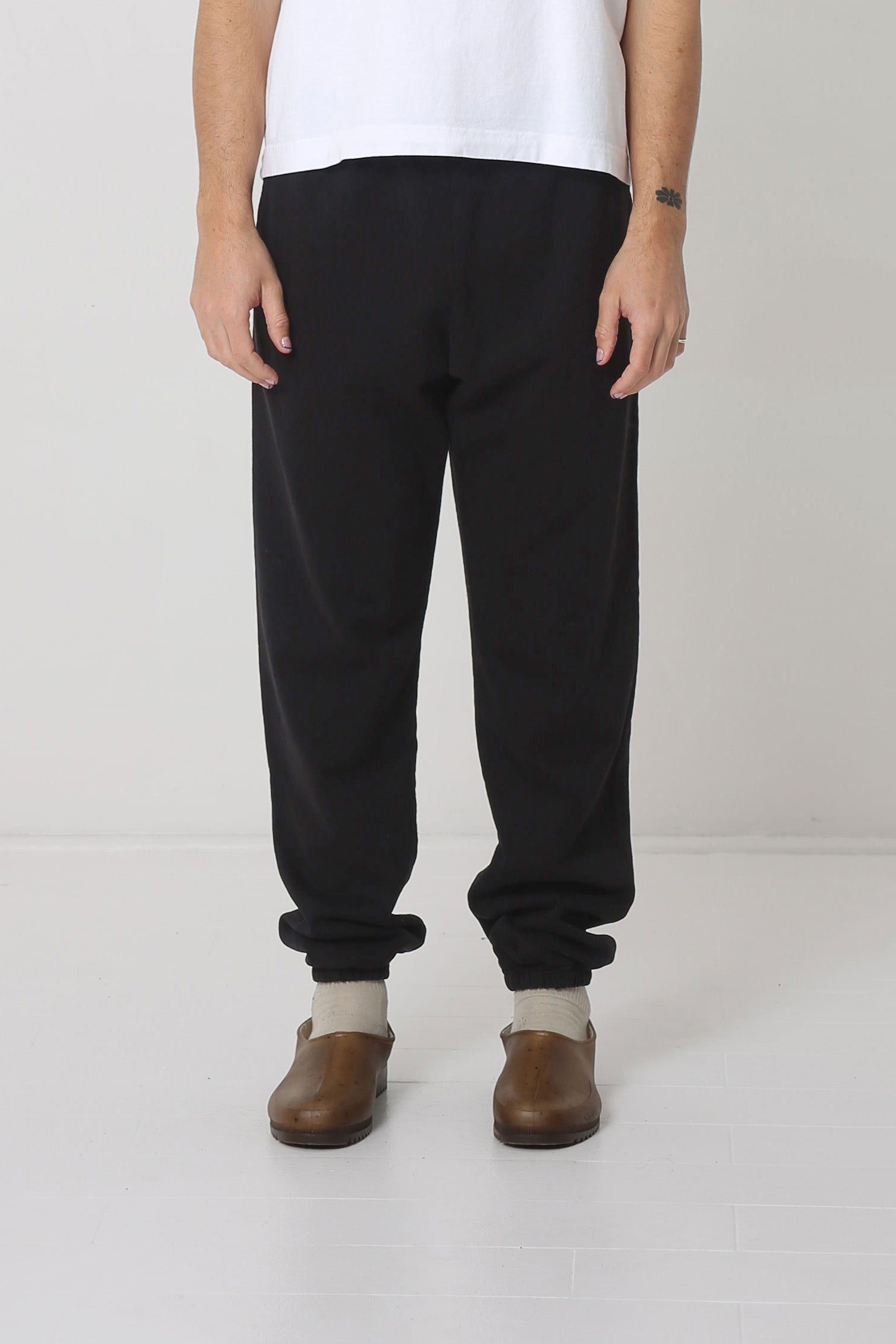 A 6' person in size M Black Trash Sweatpants. Bunching at the ankles.