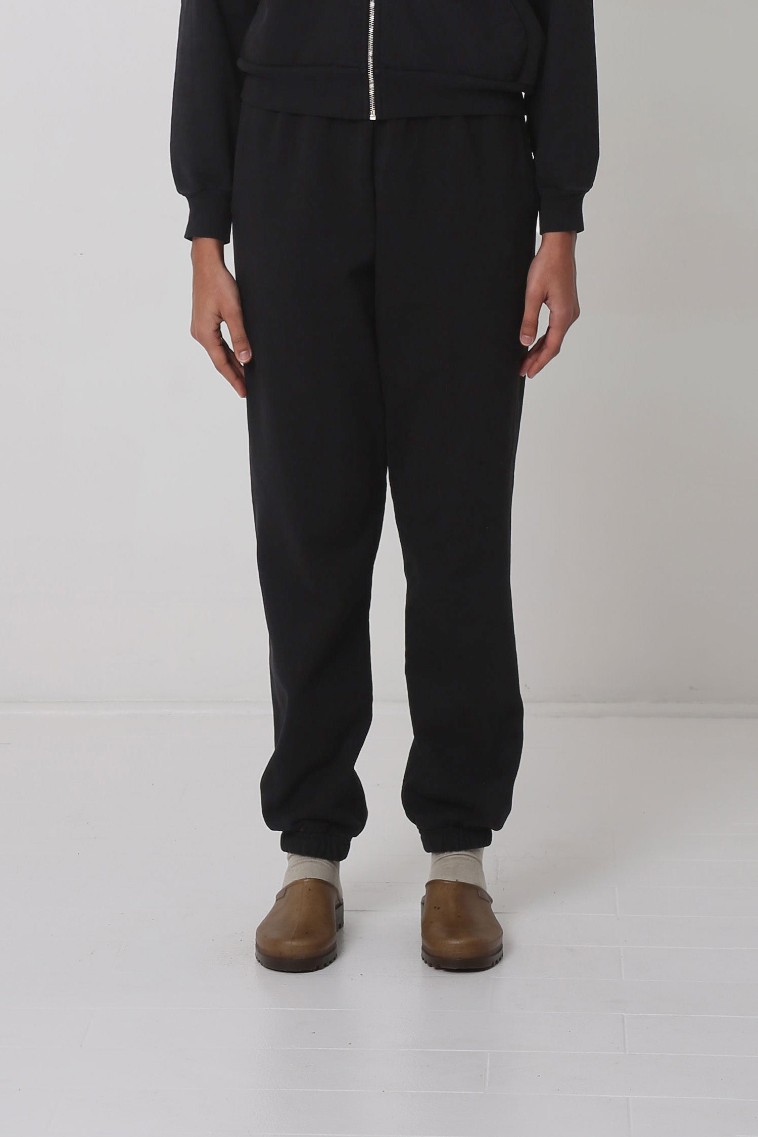 5'10" person in size S Black Trash Sweatpants. Slight bunching at the ankles.