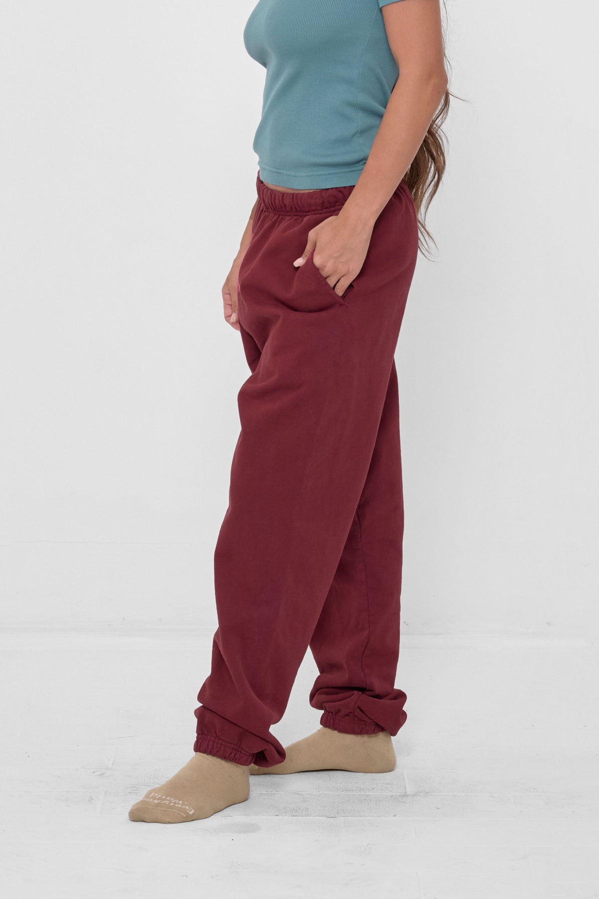 Trash Sweatpants in Garnet – 3/4 front view on model