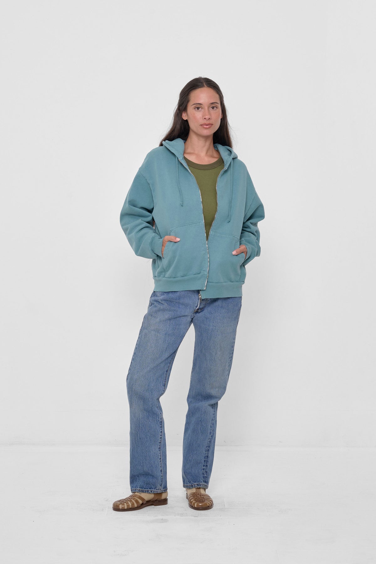 Trash Zip Up Hoodie in Oyster – front view, model's hands in kangaroo pockets