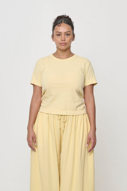 5'7" woman in a French Butter Tailored Trash Tee in Size S, shirt hem hits her upper hip.