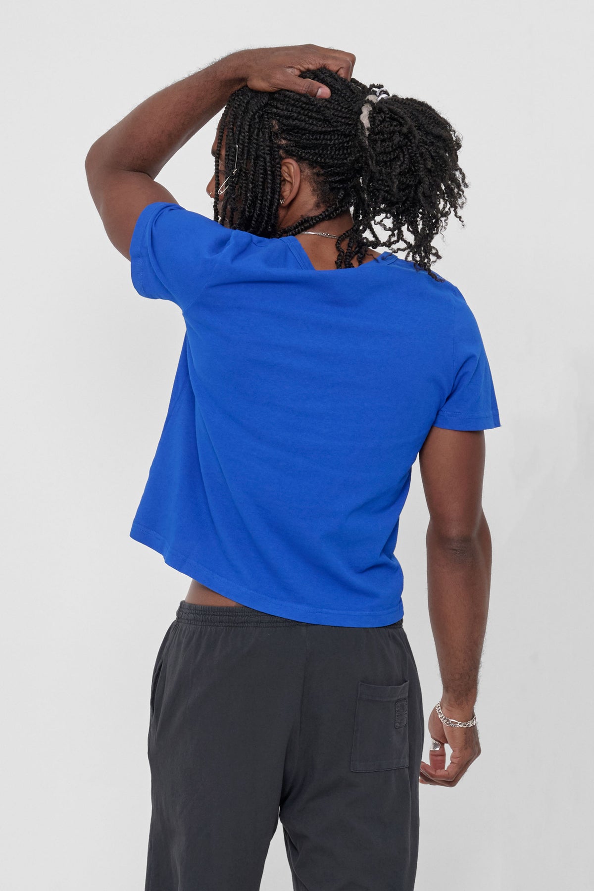 Tailored Trash Tee in Lapis – on a model facing back
