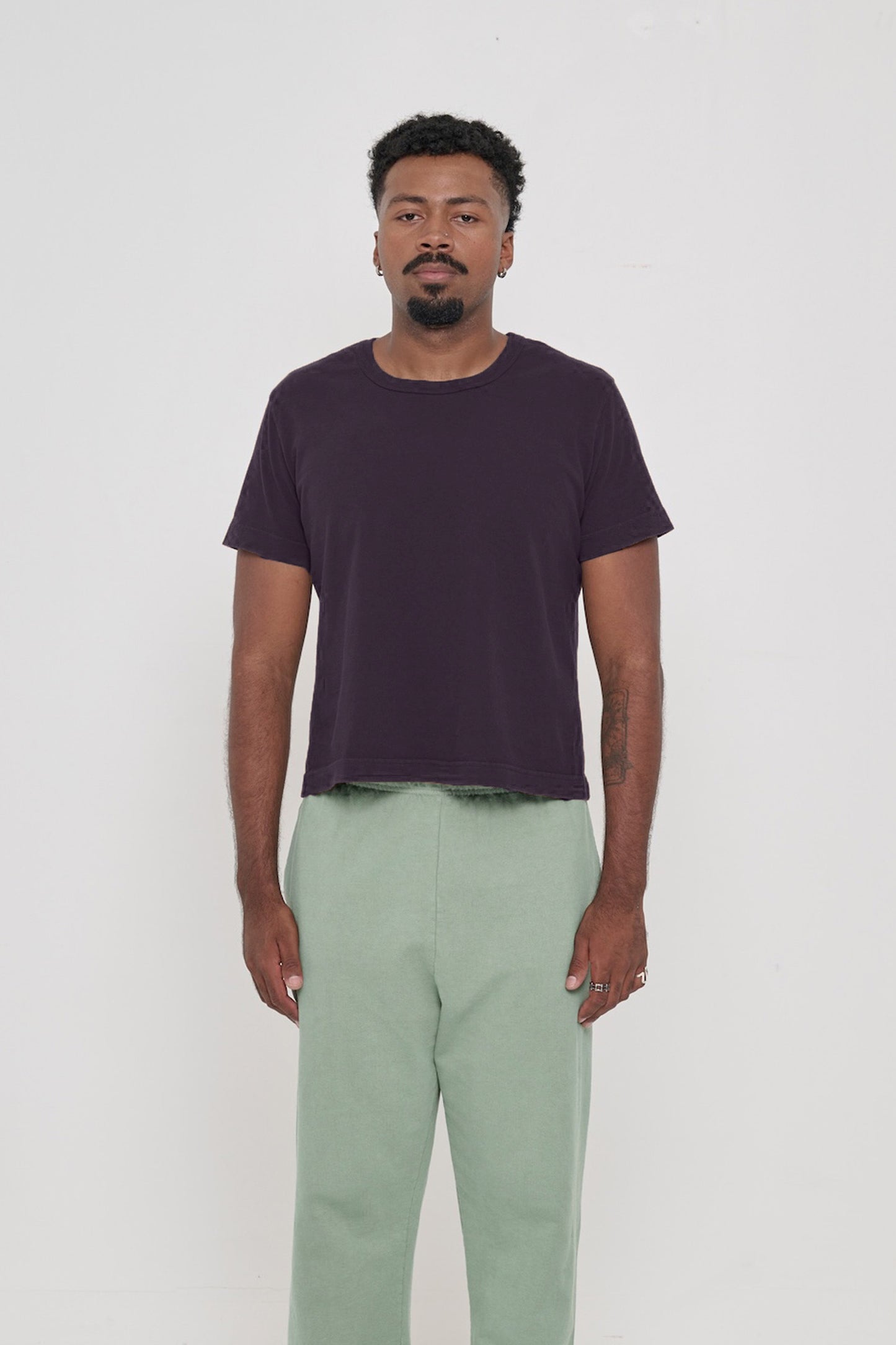 6'2" man wearing a Mulberry Tailored Trash Tee, shirt hem hits his upper hip. 