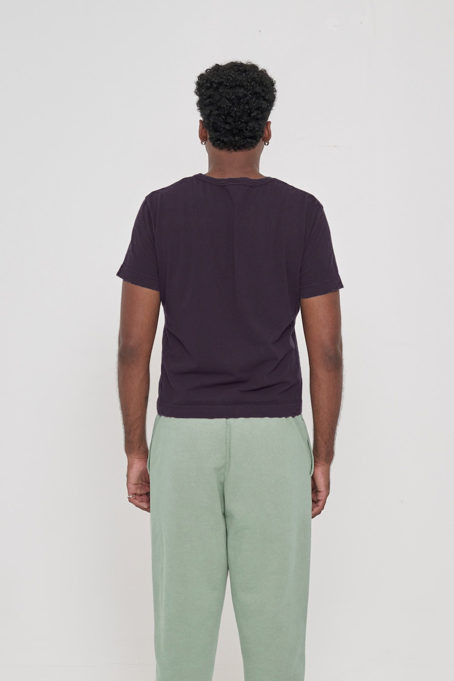 Tailored Trash Tee in Mulberry, back view on a man, showcasing a relaxed slim fit throughout. 