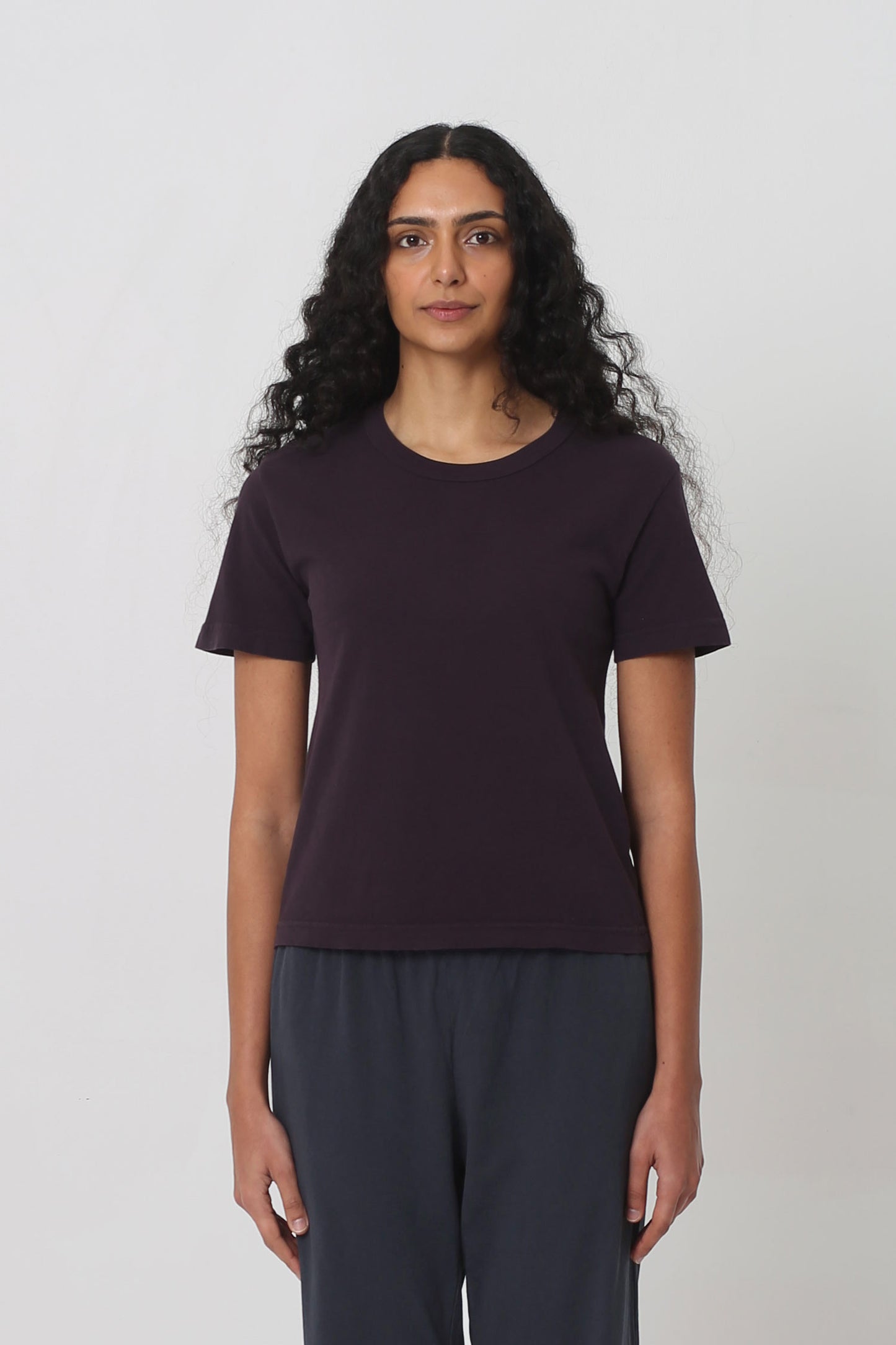 5'10" woman in a Mulberry Tailored Trash Tee in Size S. Shirt hem ends at her upper-middle hip.