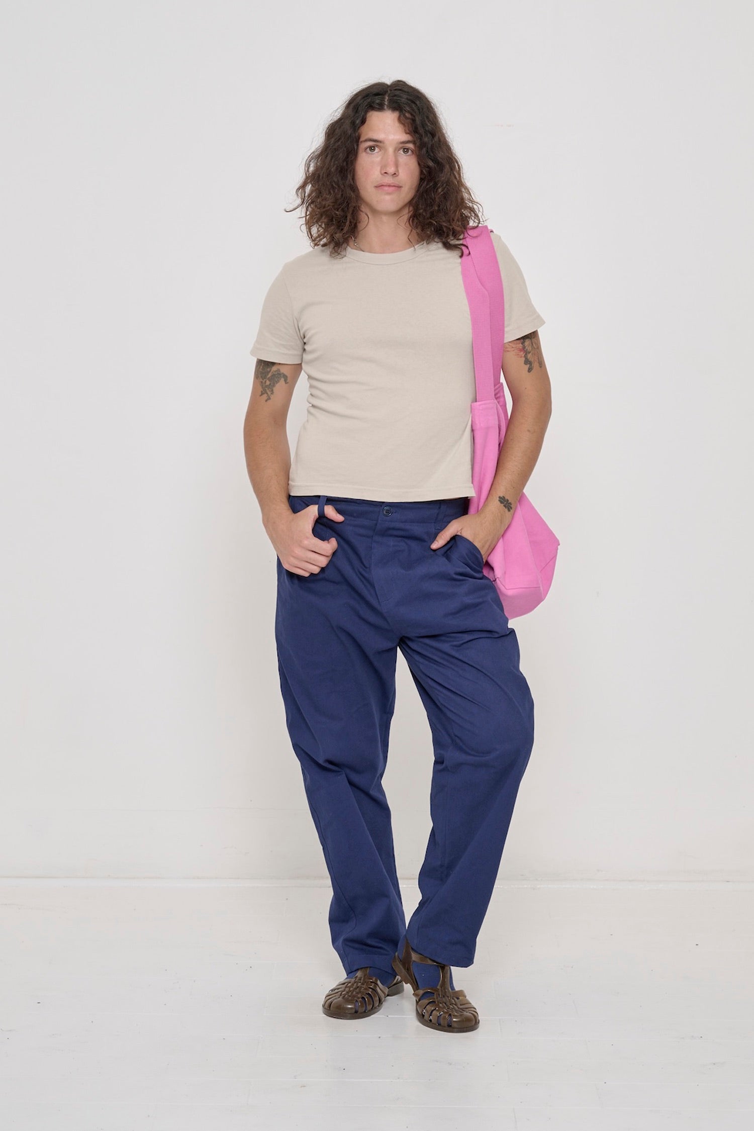 Person wearing Oat Tailored Trash Tee with Washed Navy Cotton Twill Life Uniform Pants.