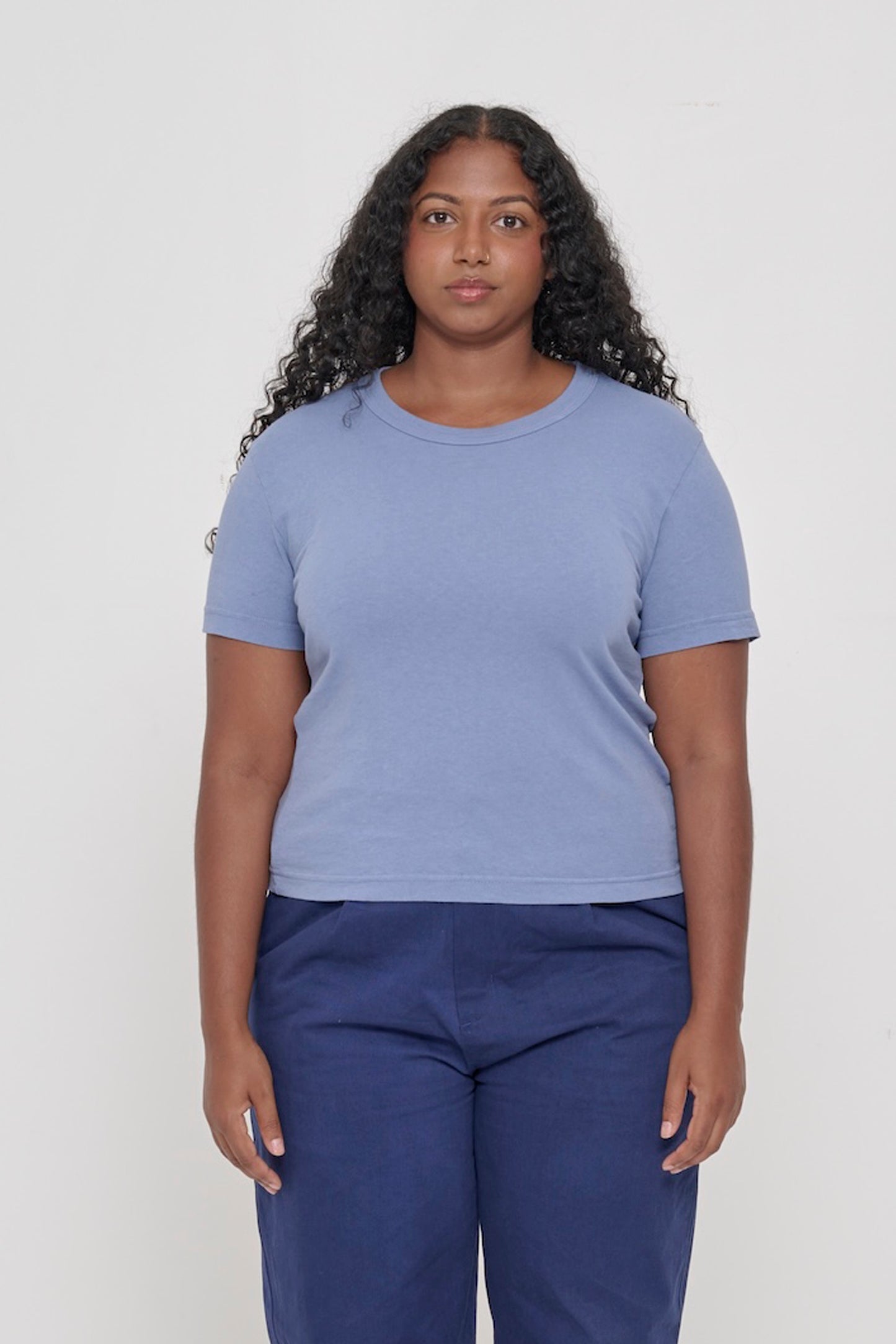 5'8" woman wearing Periwinkle Tailored Trash Tee, shirt hem hits her upper-middle hip. 