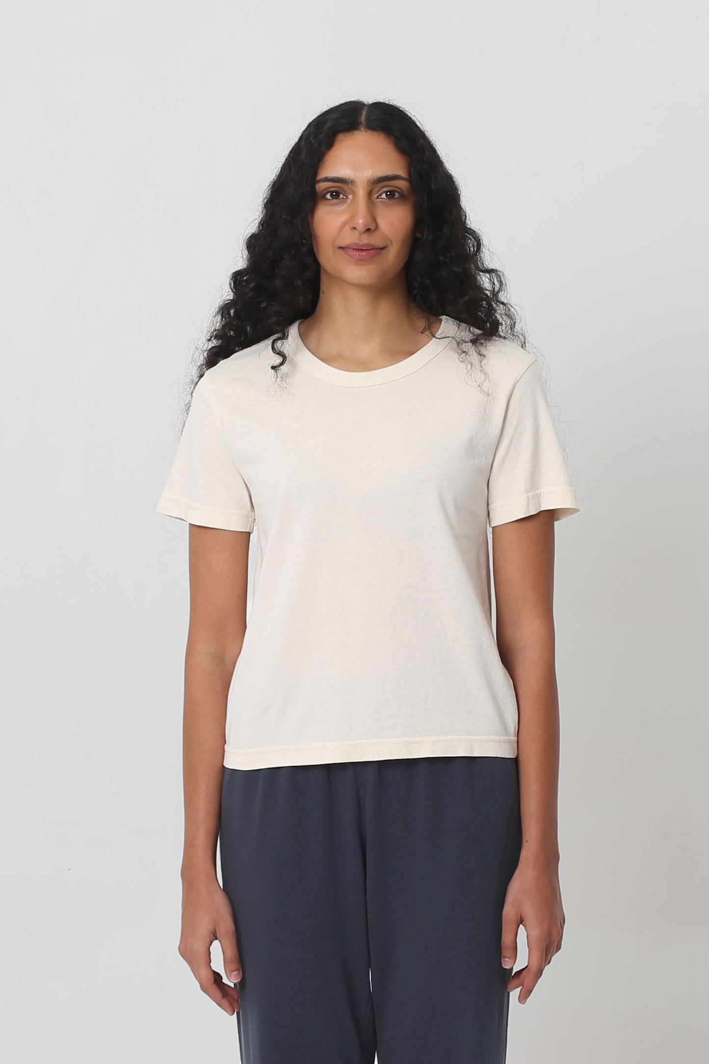 5'10" woman in a Scour Tailored Trash Tee in Size S. Shirt hem ends at her upper-middle hip. 
