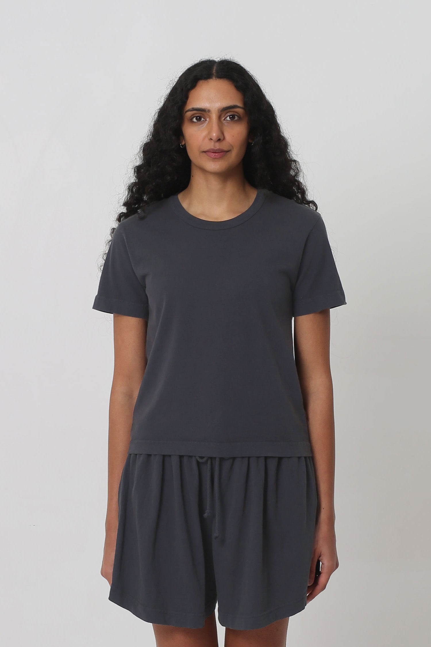 5'10" woman in a Slate Tailored Trash Tee in Size S. Shirt hem ends at her upper-middle hip. 