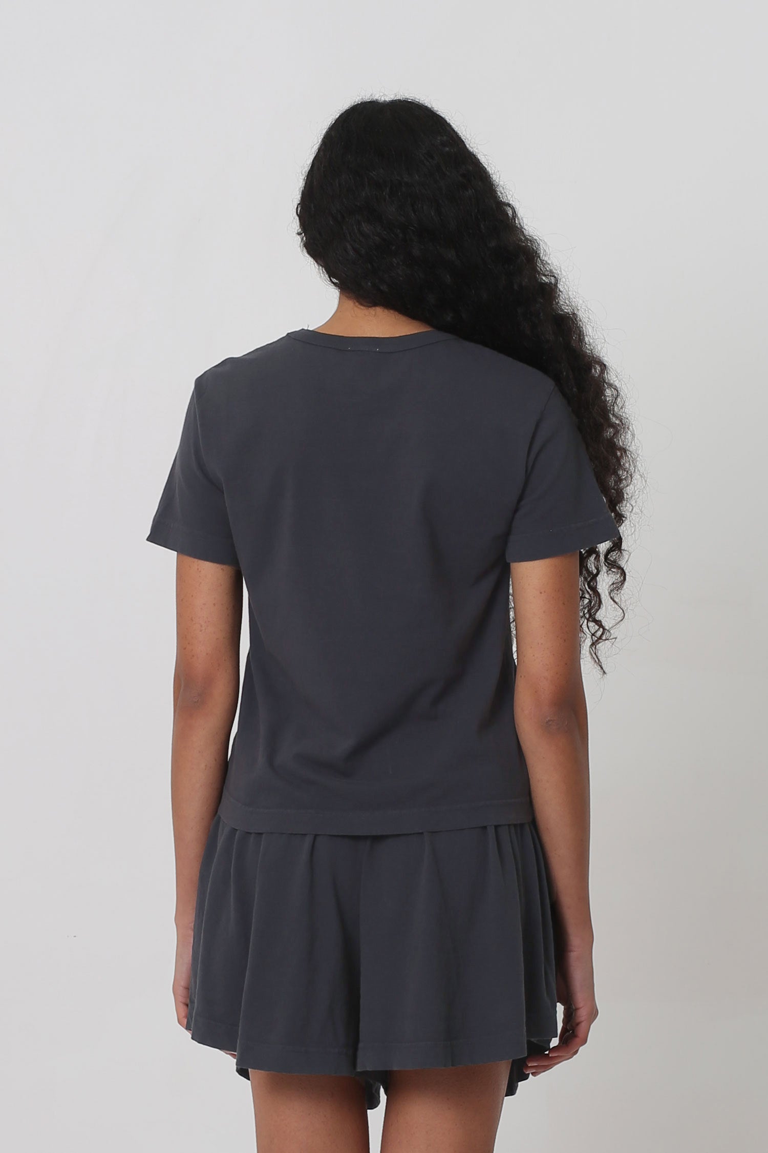 Back view: slightly fitted across upper back and relaxed ease at lower back.