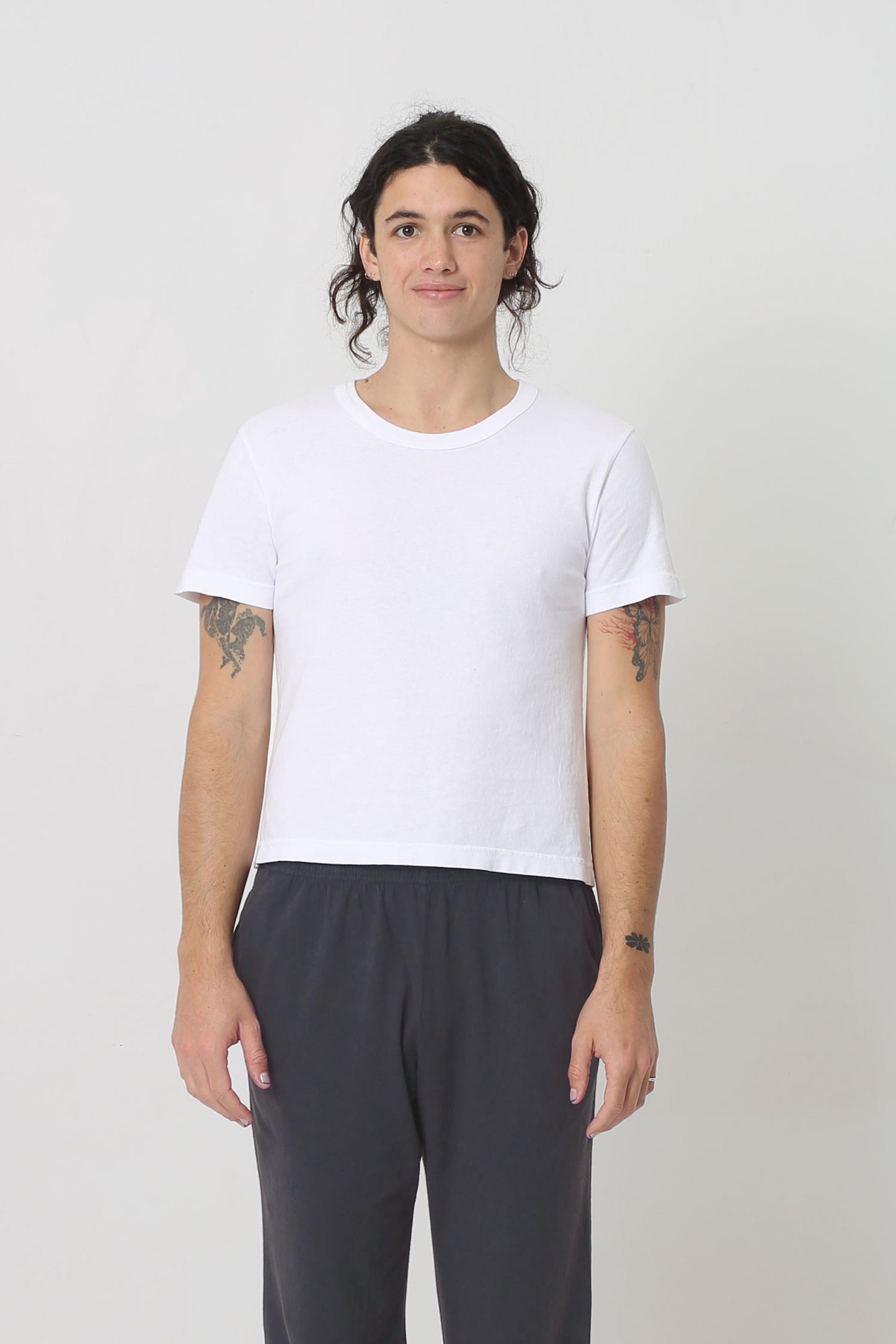 6' person in a White Tailored Trash Tee in Size M. Shirt hem hits their upper hip. 
