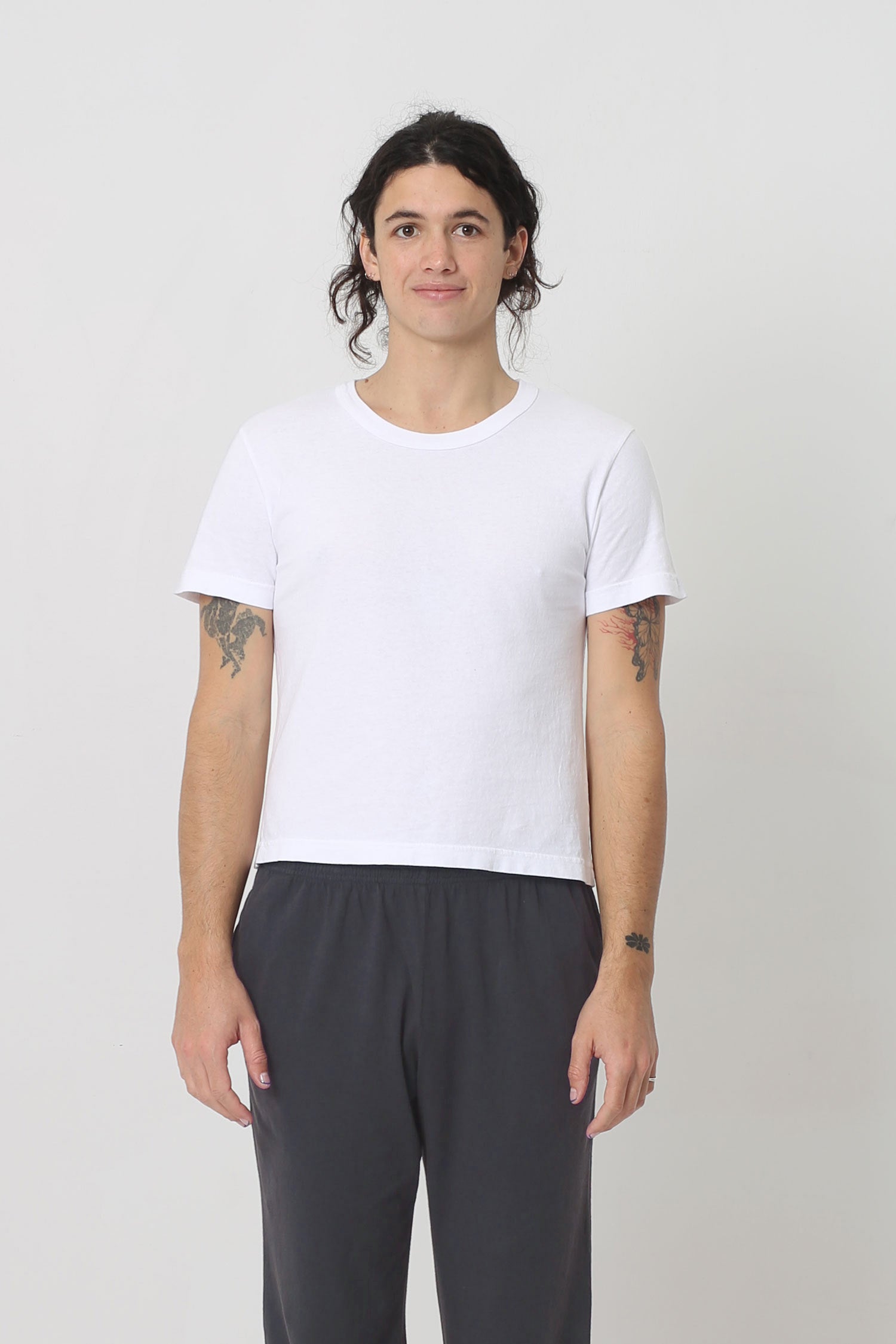 6' person in a White Tailored Trash Tee in Size M. Shirt hem hits their upper hip. 