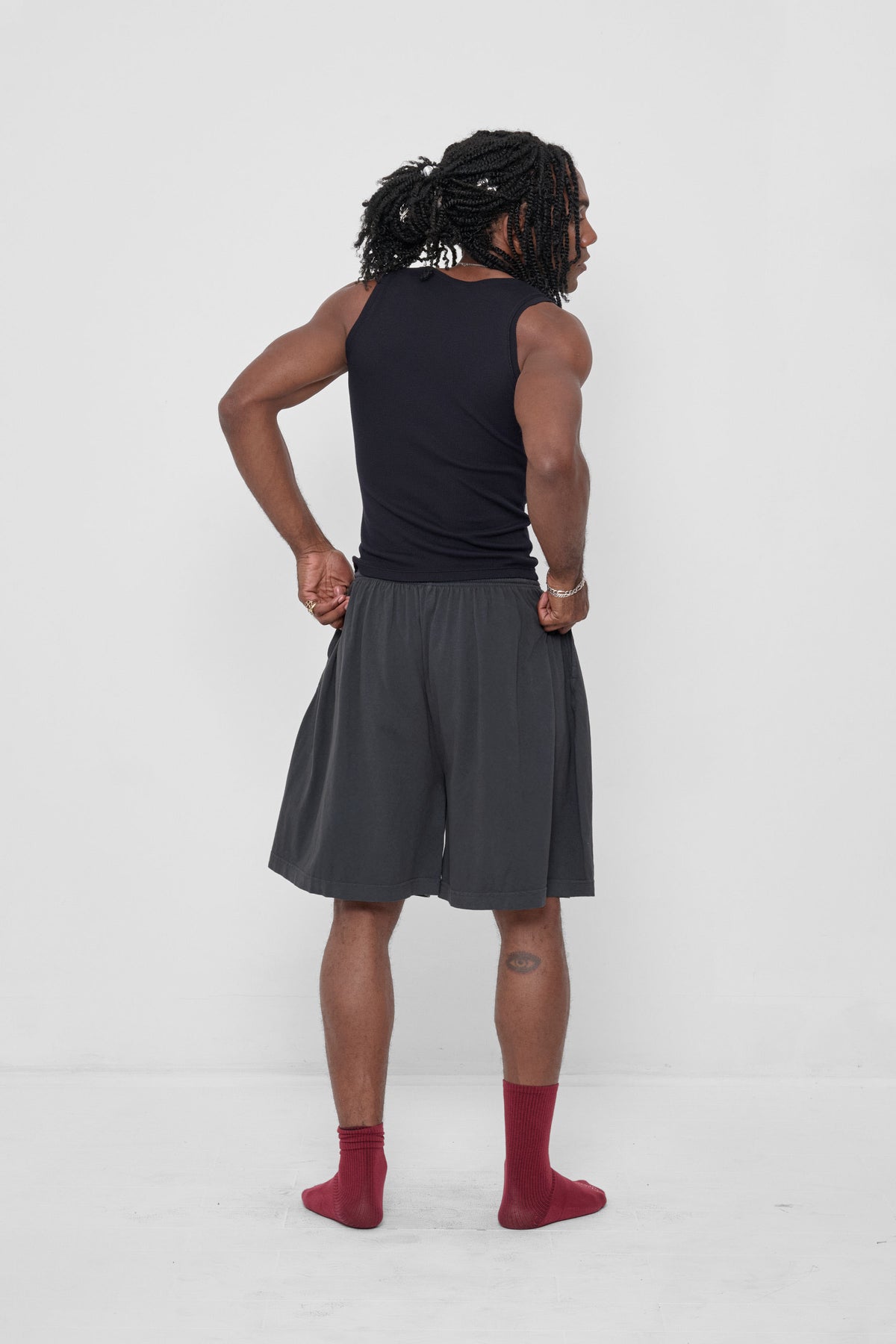 The Tank in Black – back full length view on model, styled with Slate Long Tubular Shorts