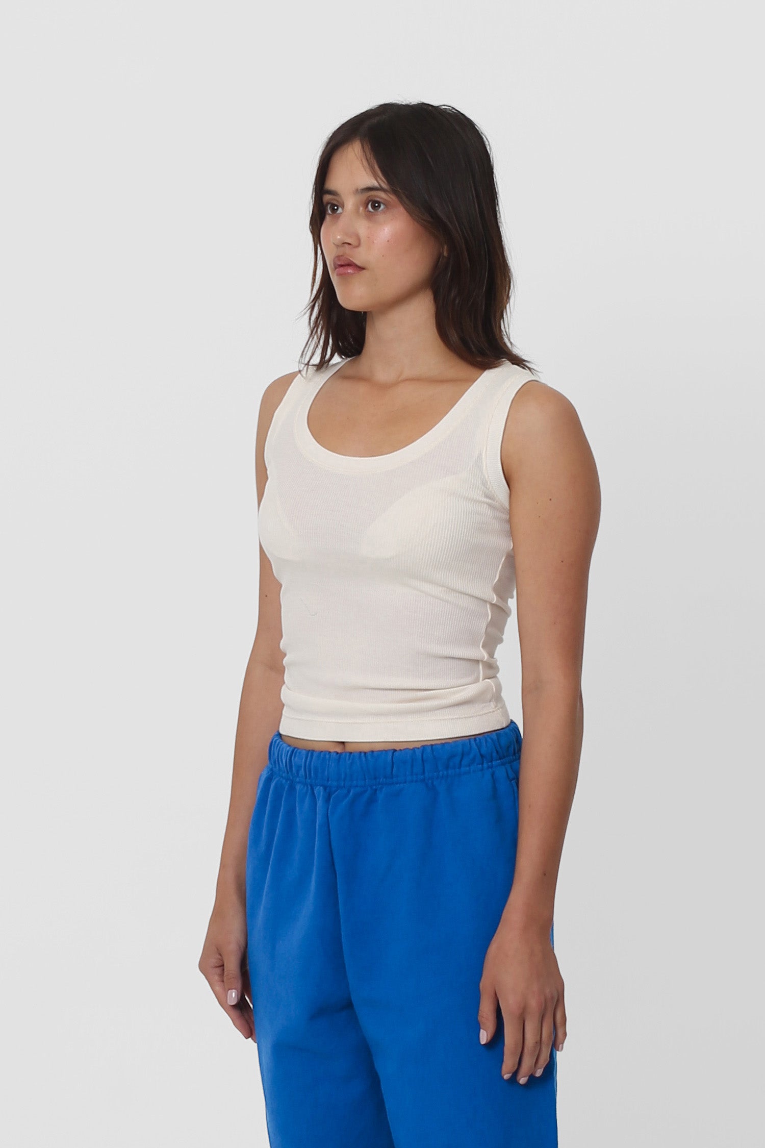 A woman facing 45-degrees showcasing side seams and fitted silhouette.