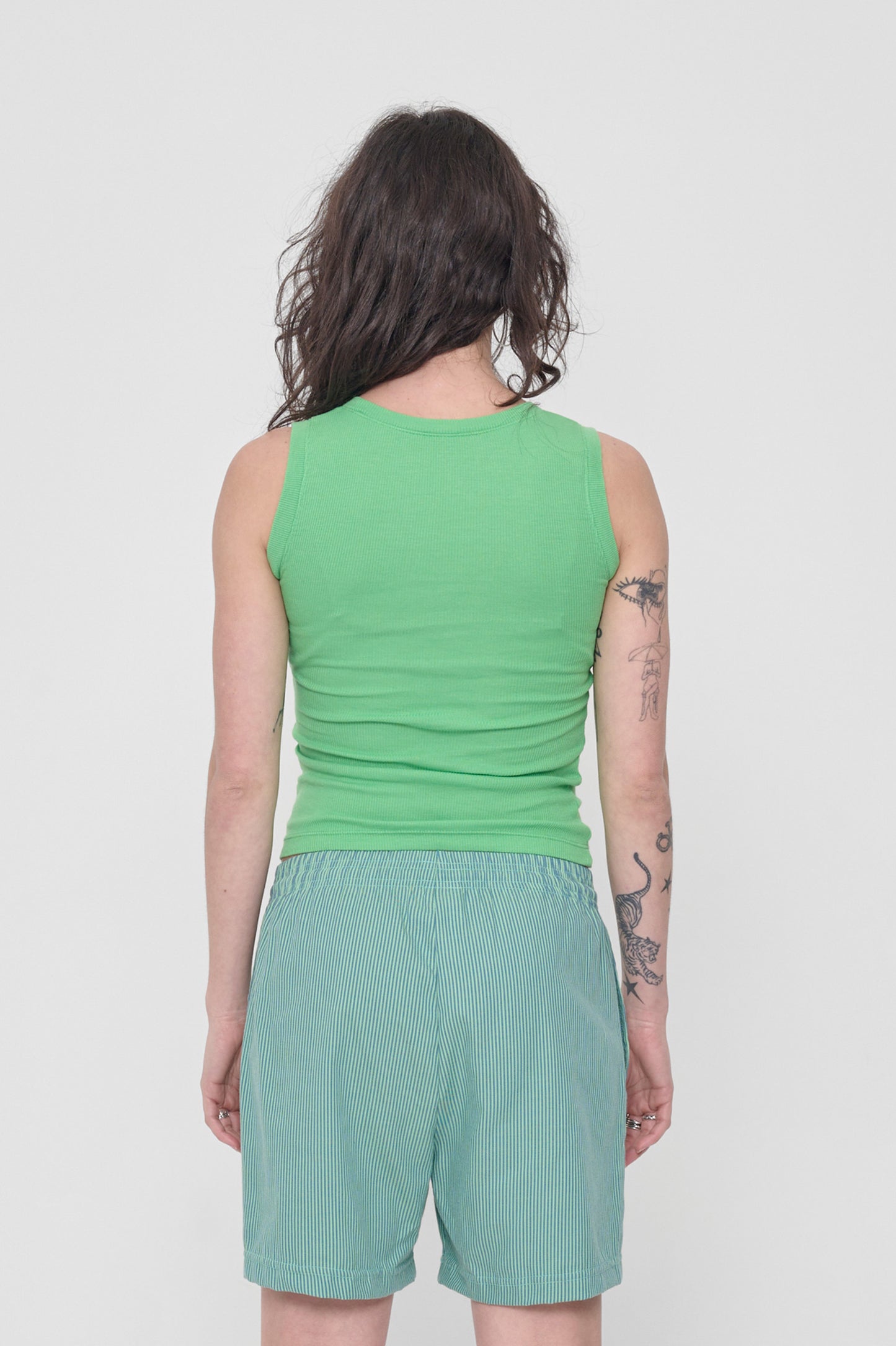 Back view: formfitting throughout and neckline higher than the front.