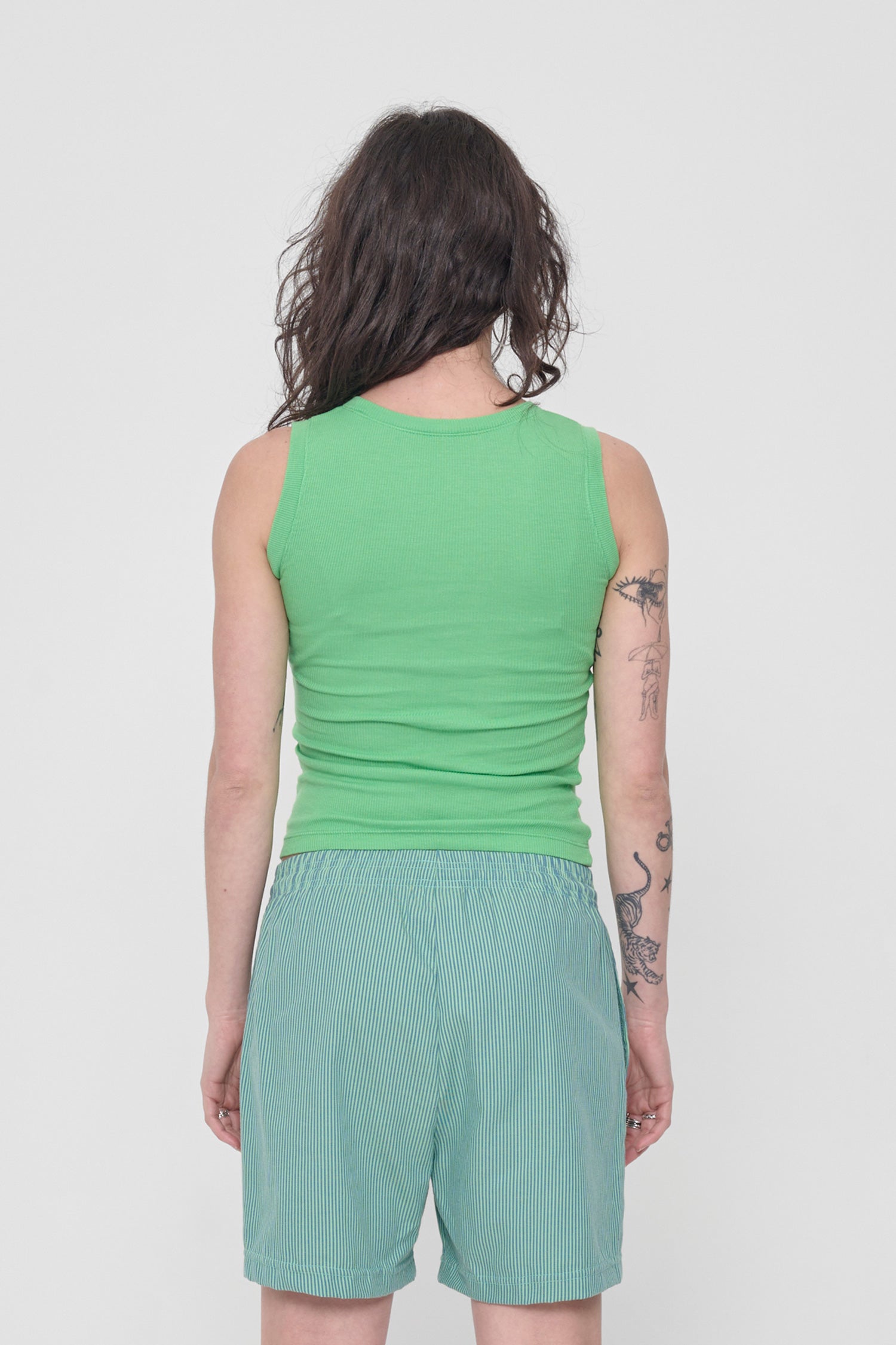 Back view: formfitting throughout and neckline higher than the front.