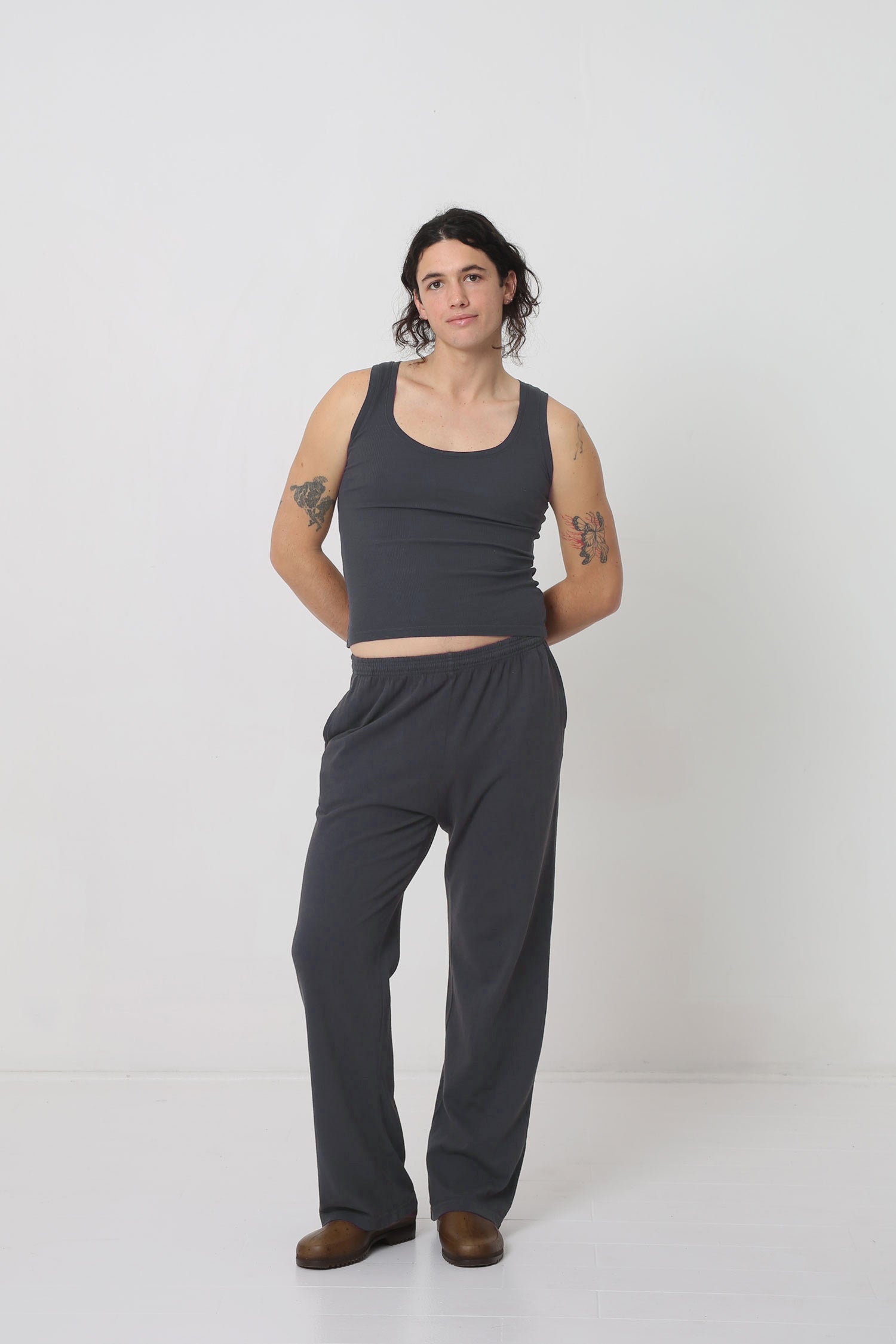 Styled with Slate Apartment Pants, exposing a sliver of lower abs.
