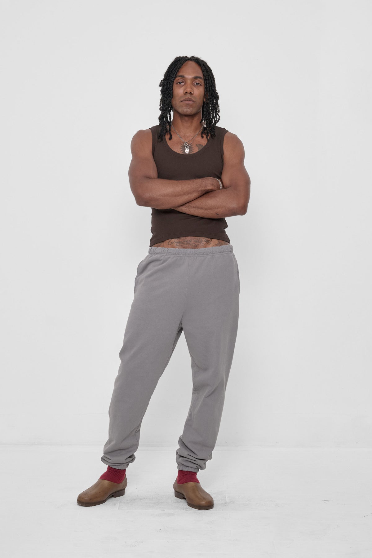 The Tank in Wet Soil – front view on model, styled with Stone Trash Sweatpants