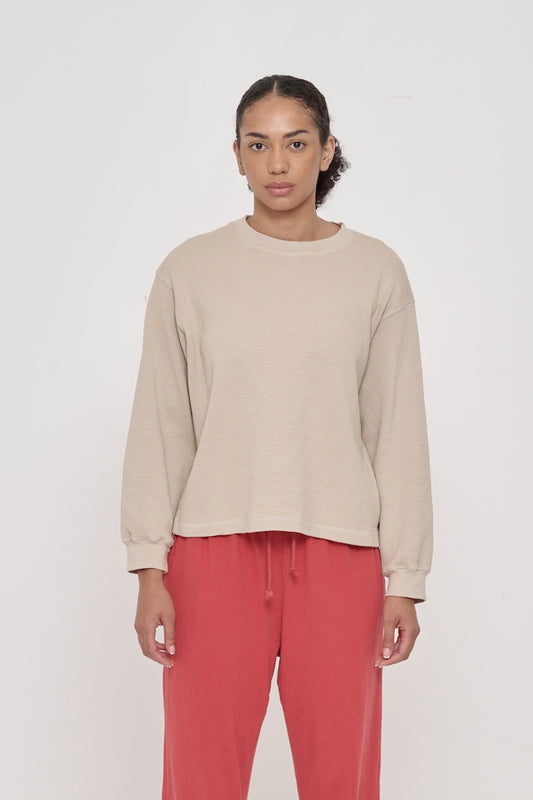 A 5'8" woman in an Oat Thermal Long Sleeve Boxier Trash Tee, size S. Bottom hem hits her upper-middle hip.