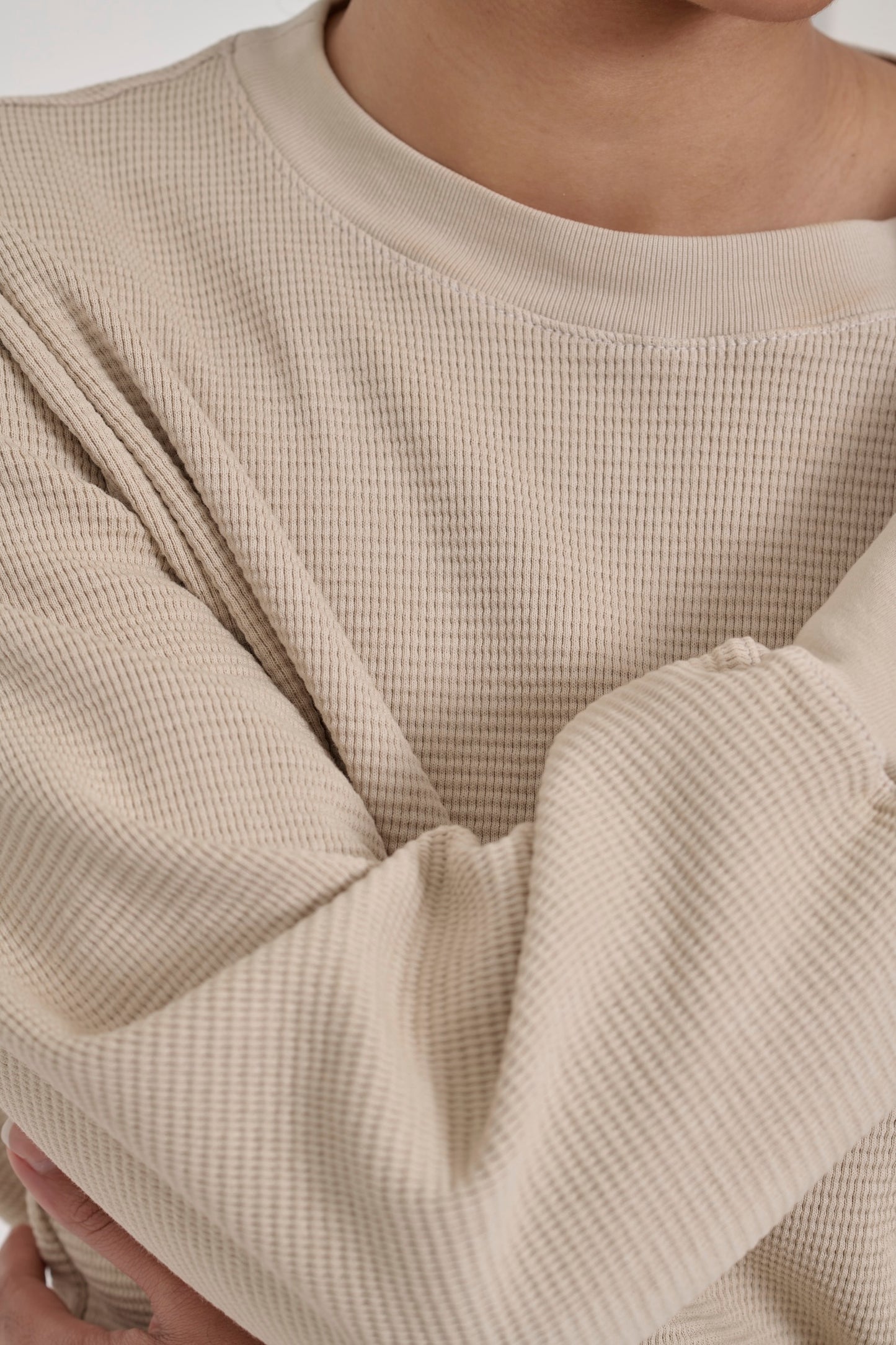 Zoom in on Oat Thermal Long Sleeve Boxier Trash Tee, highlighting the chunky waffle knit and rib neckband.