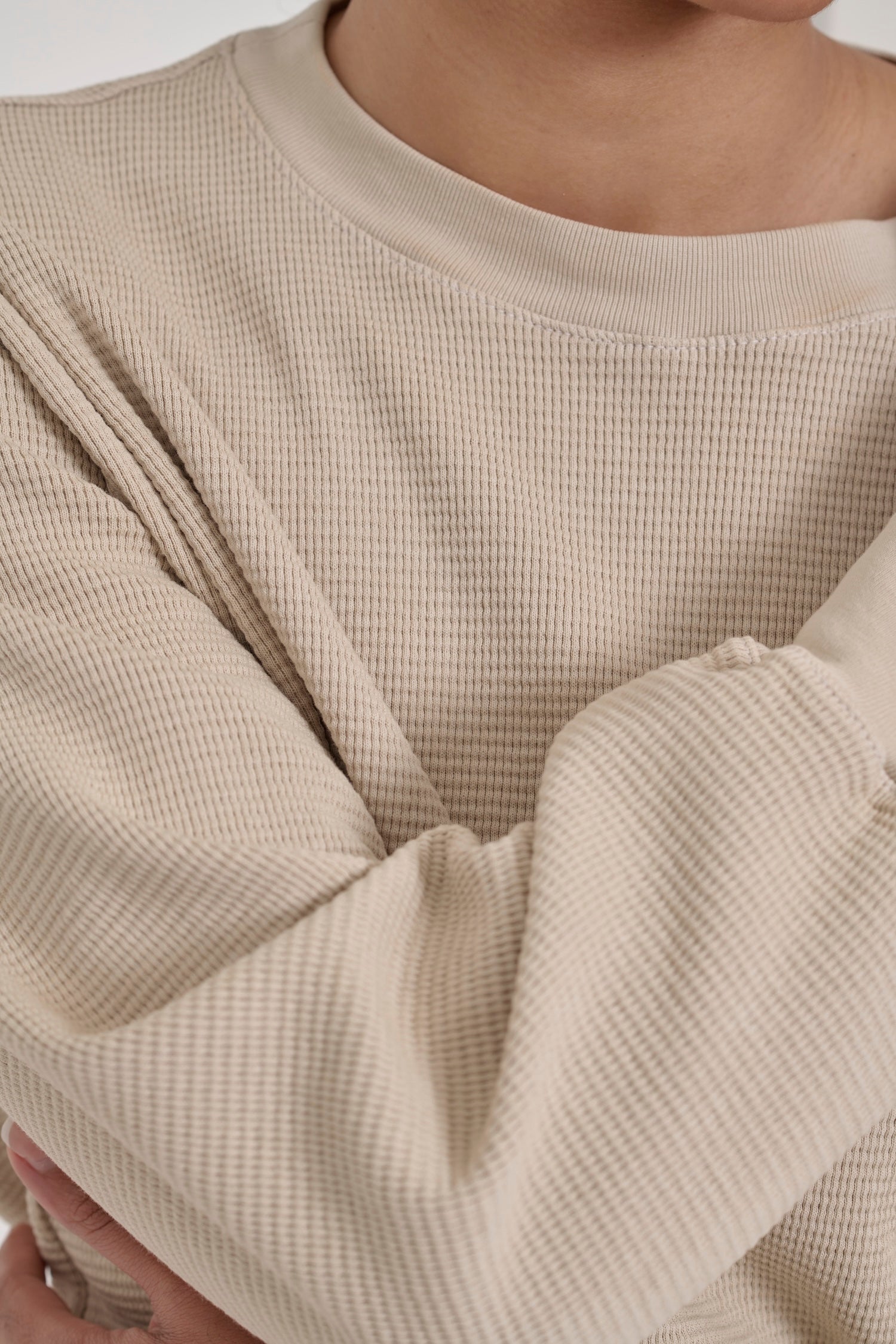 Zoom in on Oat Thermal Long Sleeve Boxier Trash Tee, highlighting the chunky waffle knit and rib neckband.