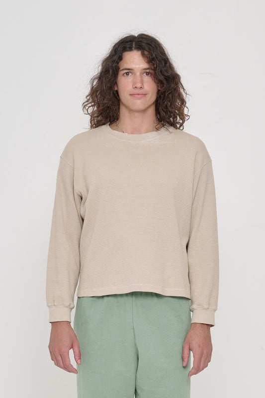 A 6'0" person wearing Oat Thermal Long Sleeve Boxier Trash Tee in size M. Shirt hem hits the top of the hip.