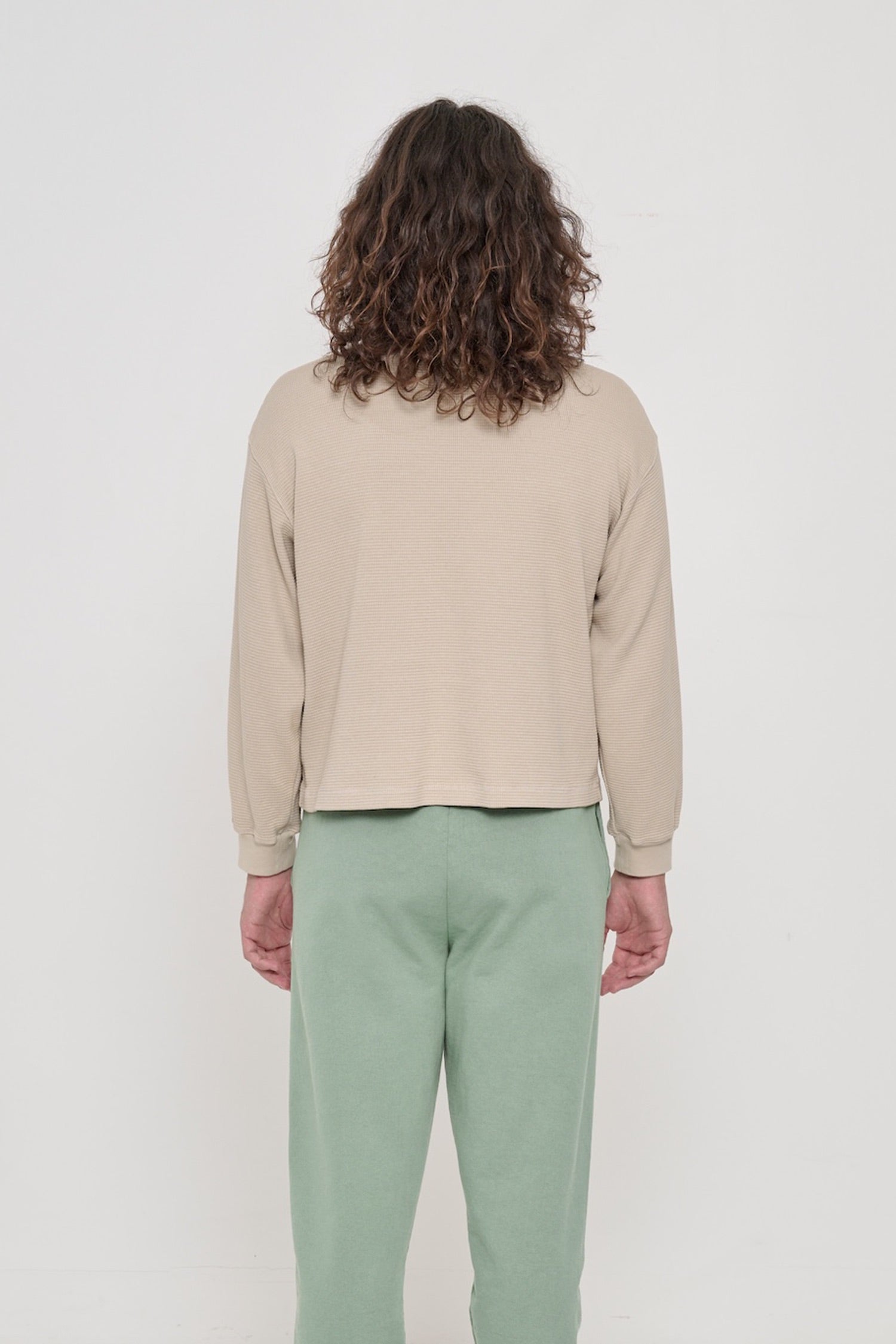 Back view: a person in an Oat Thermal Long Sleeve Boxier Trash Tee. Relaxed fit throughout.