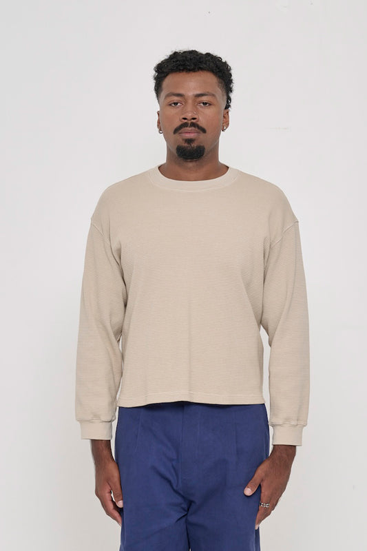 A 6'2" man in a size M Oat Thermal Long Sleeve Boxier Trash Tee. Hem hits the upper hip.