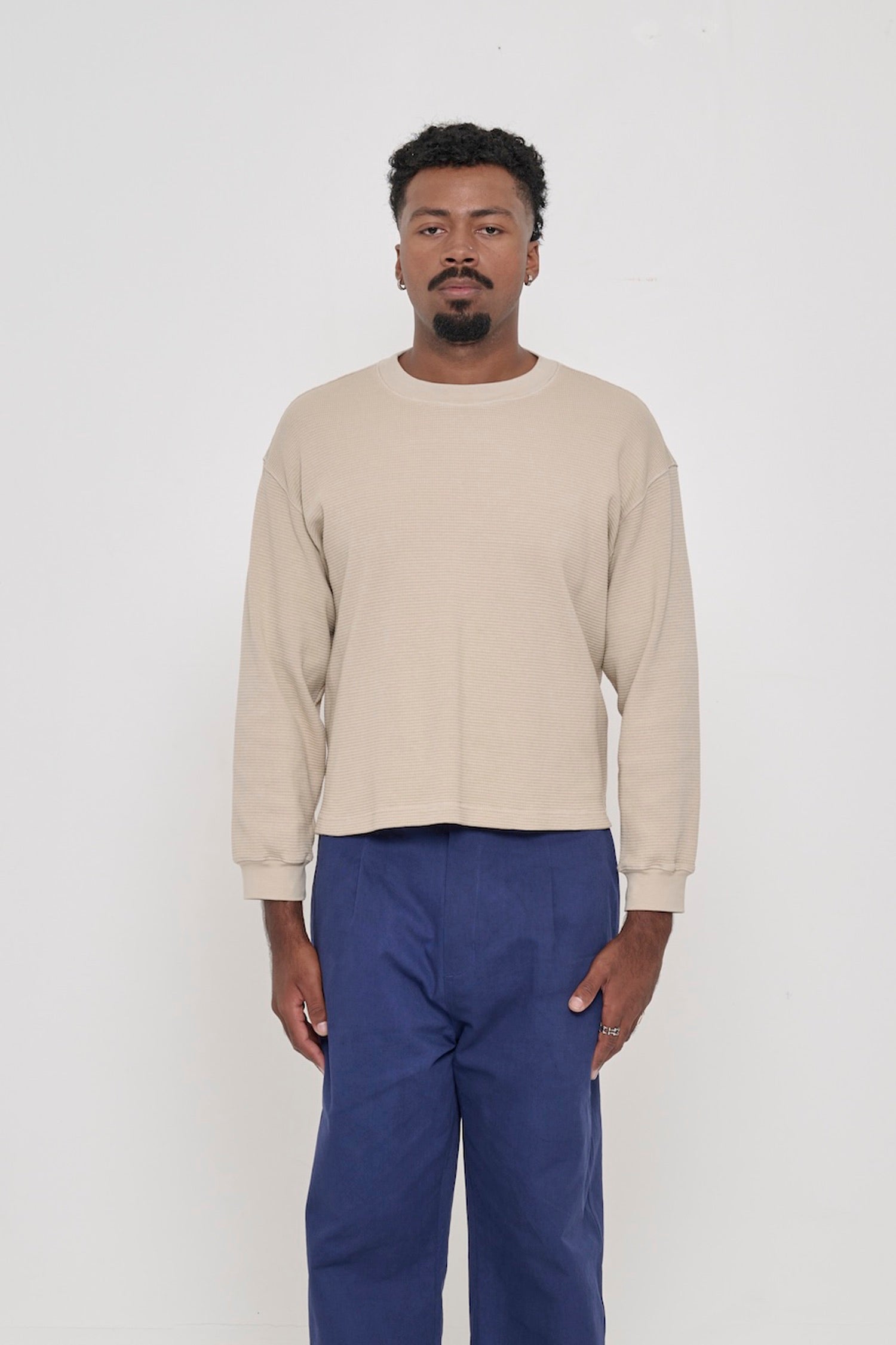 A 6'2" person in an Oat Thermal Long Sleeve Boxier Trash Tee in size M. Shirt hem hits the upper hip. 