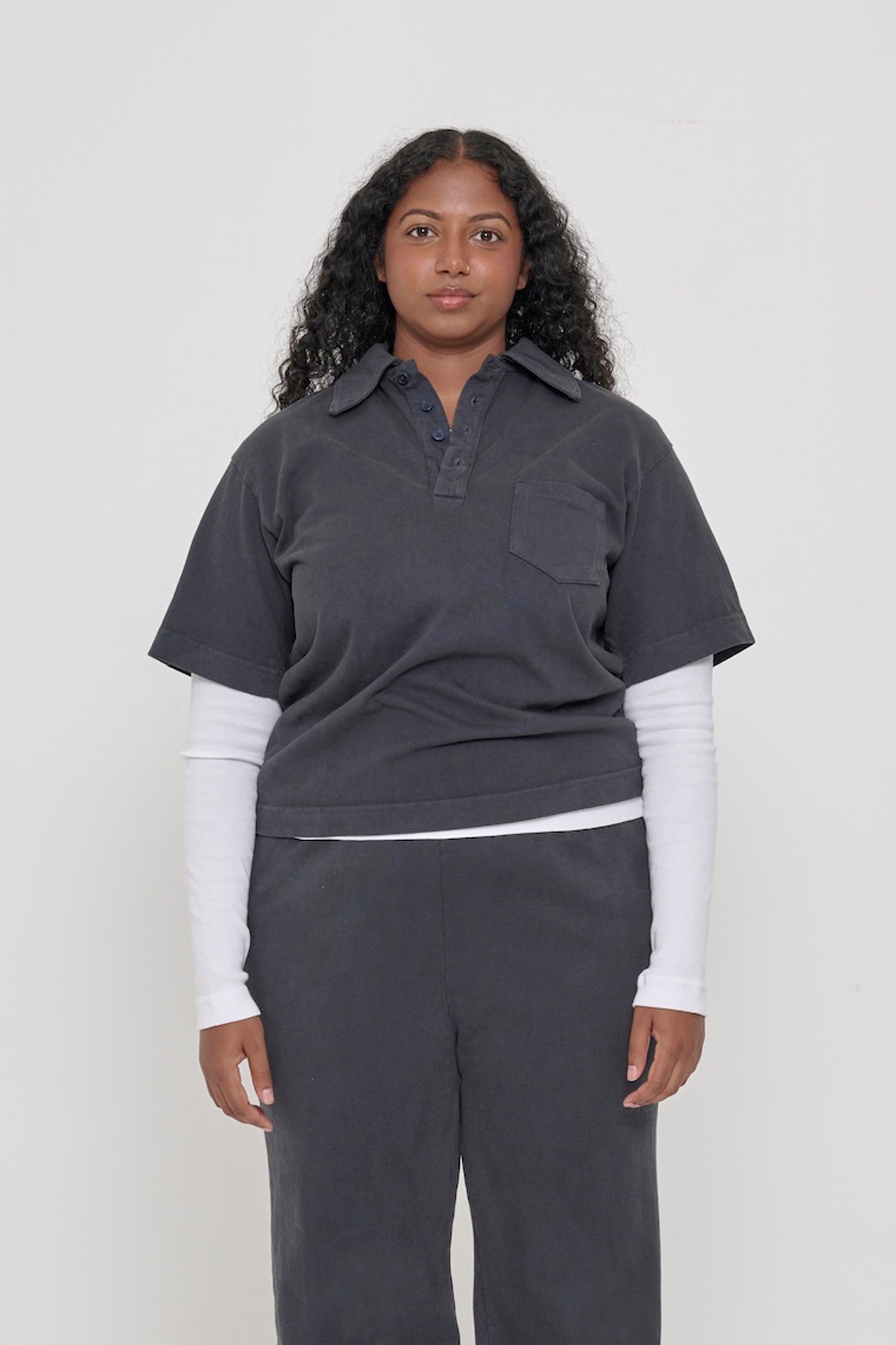 A 5'8" woman in a size S Slate Trash Polo layered over a White Rib Long Sleeve. Hem hits her upper hip.