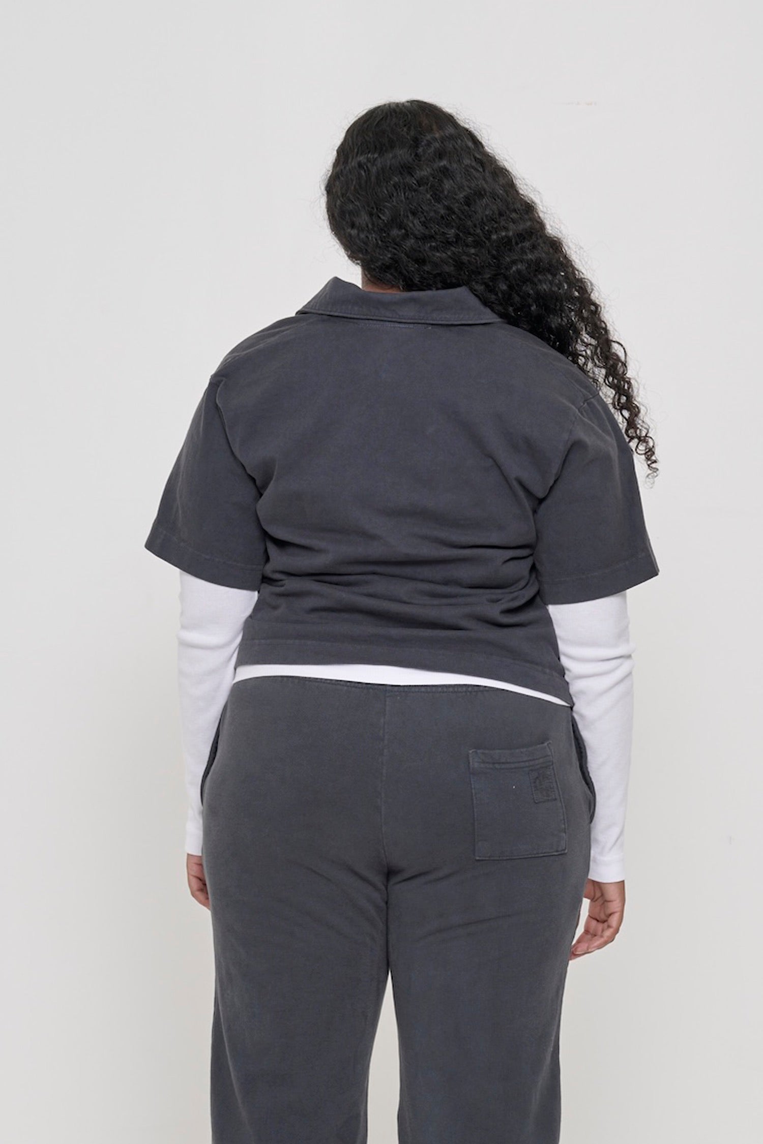 Slate Trash Polo, back view on a woman. Styled with slouchy gathers at the bottom.