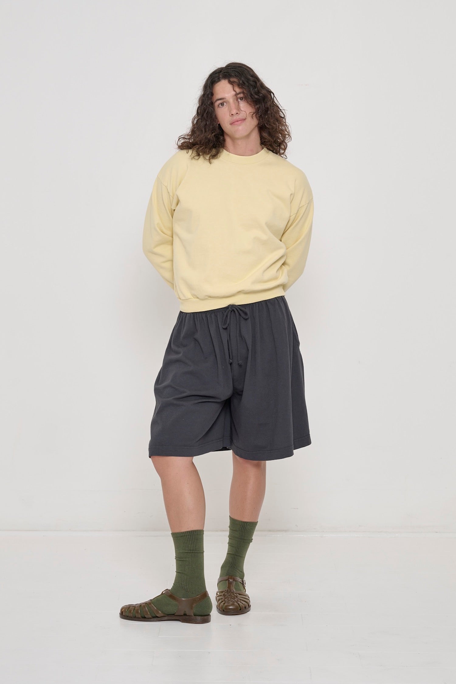 Person wearing French Butter Trash Crewneck and Slate Long Tubular Shorts. 