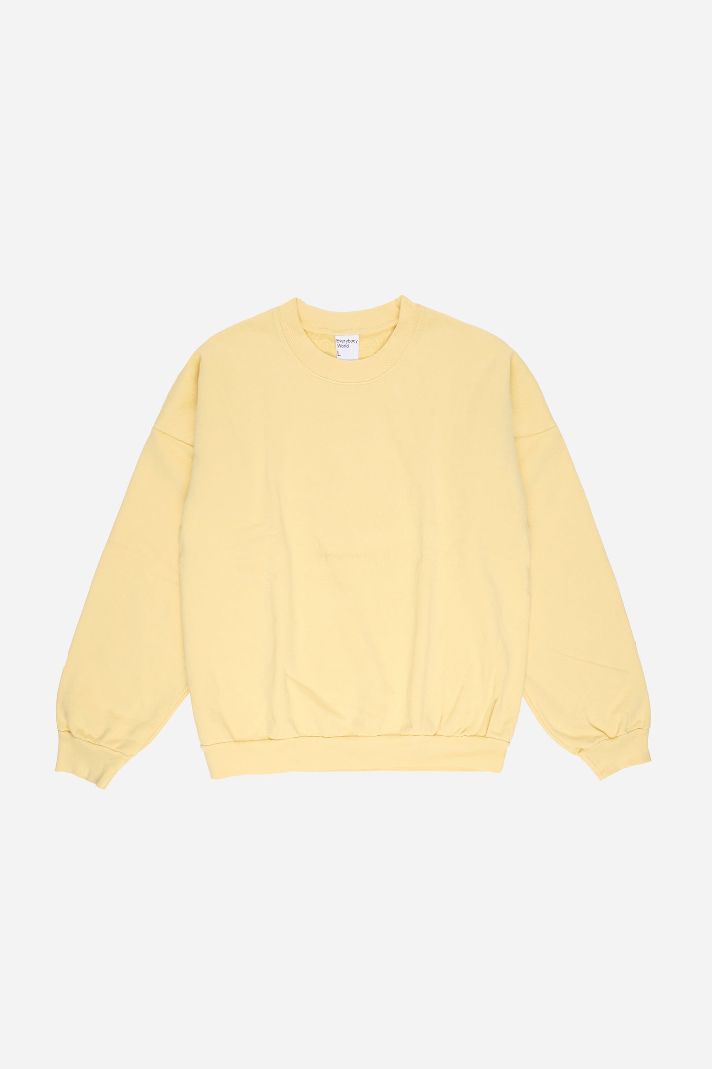 Flat lay front view of light yellow French Butter Trash Crewneck.