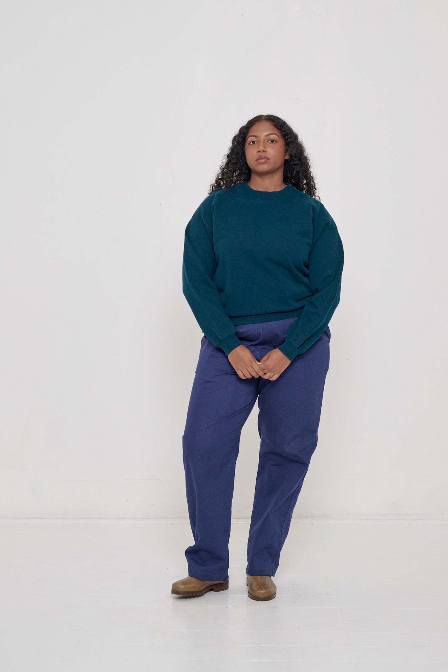 Woman wearing Juniper Trash Crewneck and Washed Navy Cotton Twill Life Uniform Pants. 