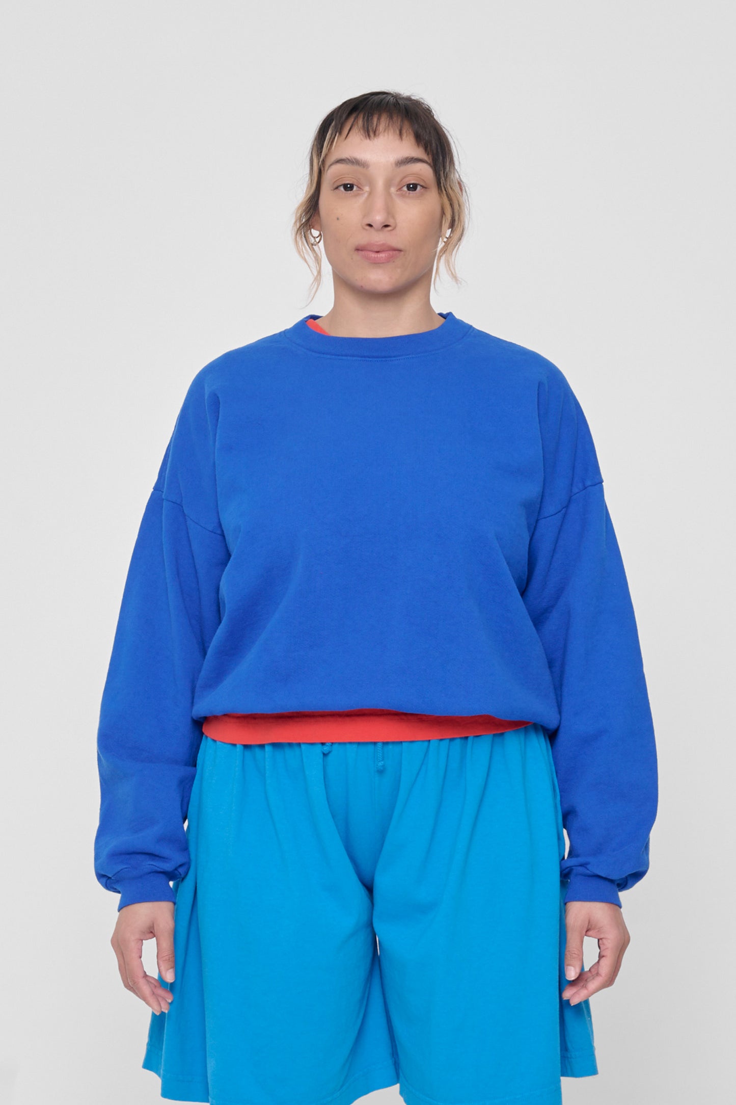 5'4" woman in a size M Lapis Trash Crewneck. Hem sits at her hip bones. 