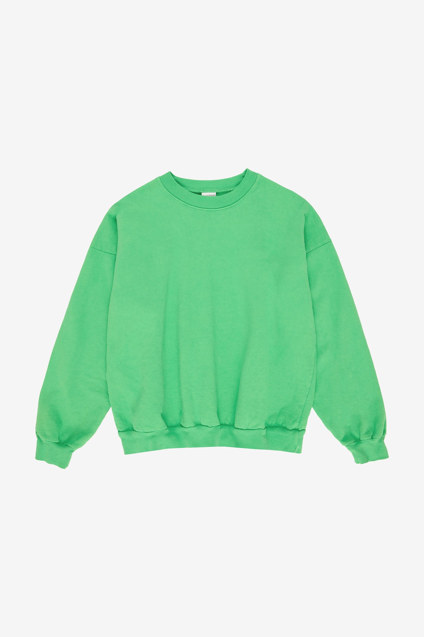 Flat lay: roomy body and sleeves with gathered fabric at rib knit cuffs and waistband.