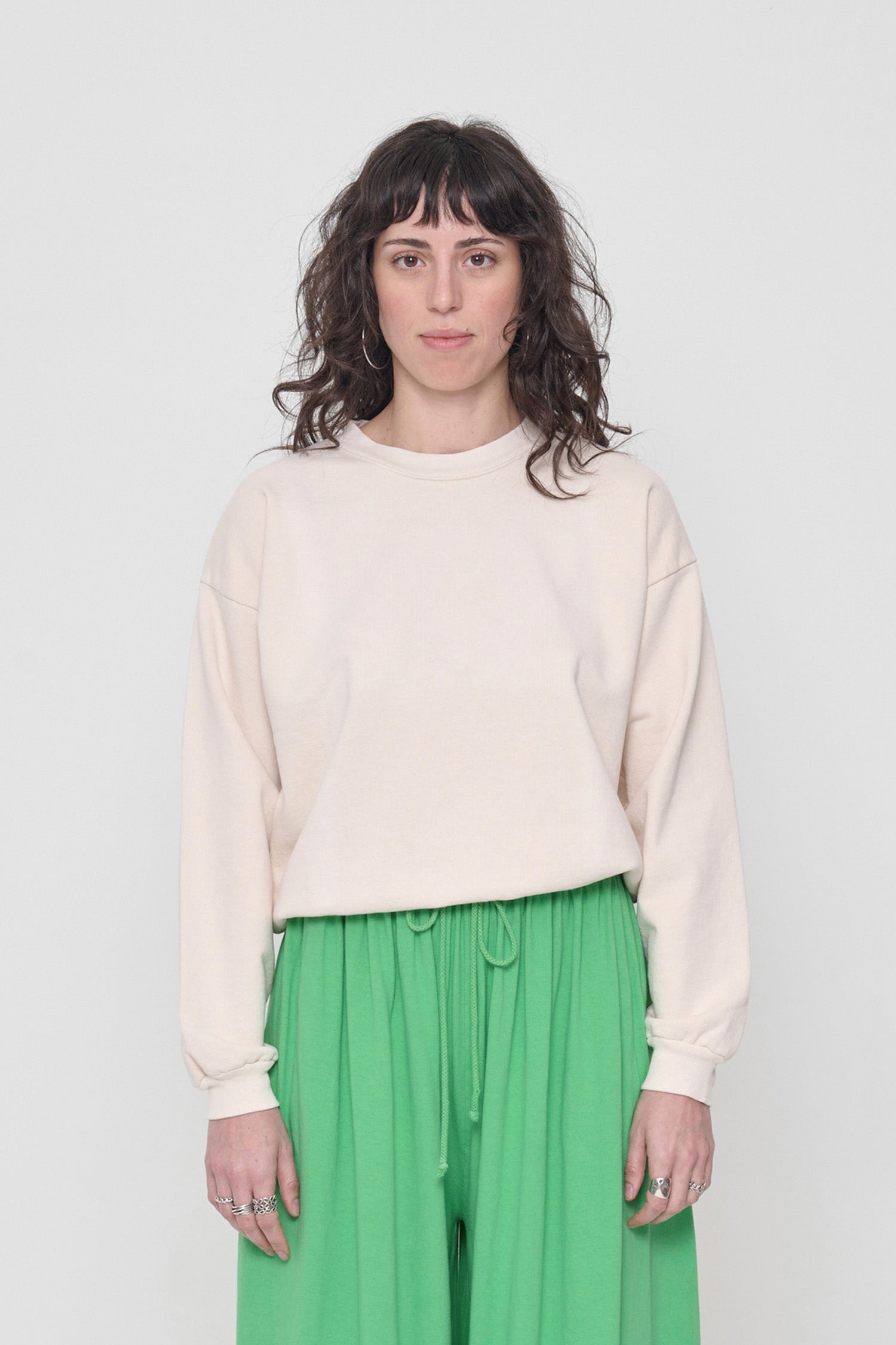 5'6" woman in a size XS Scour Trash Crewneck. Hem sits at her hip bones. 