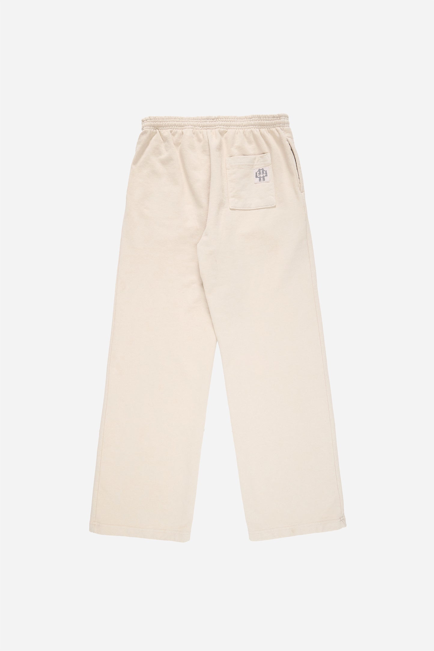 Flat lay of Trash Fleece Apartment Pants in Oat, showing the back of the leg and the pocket detail.