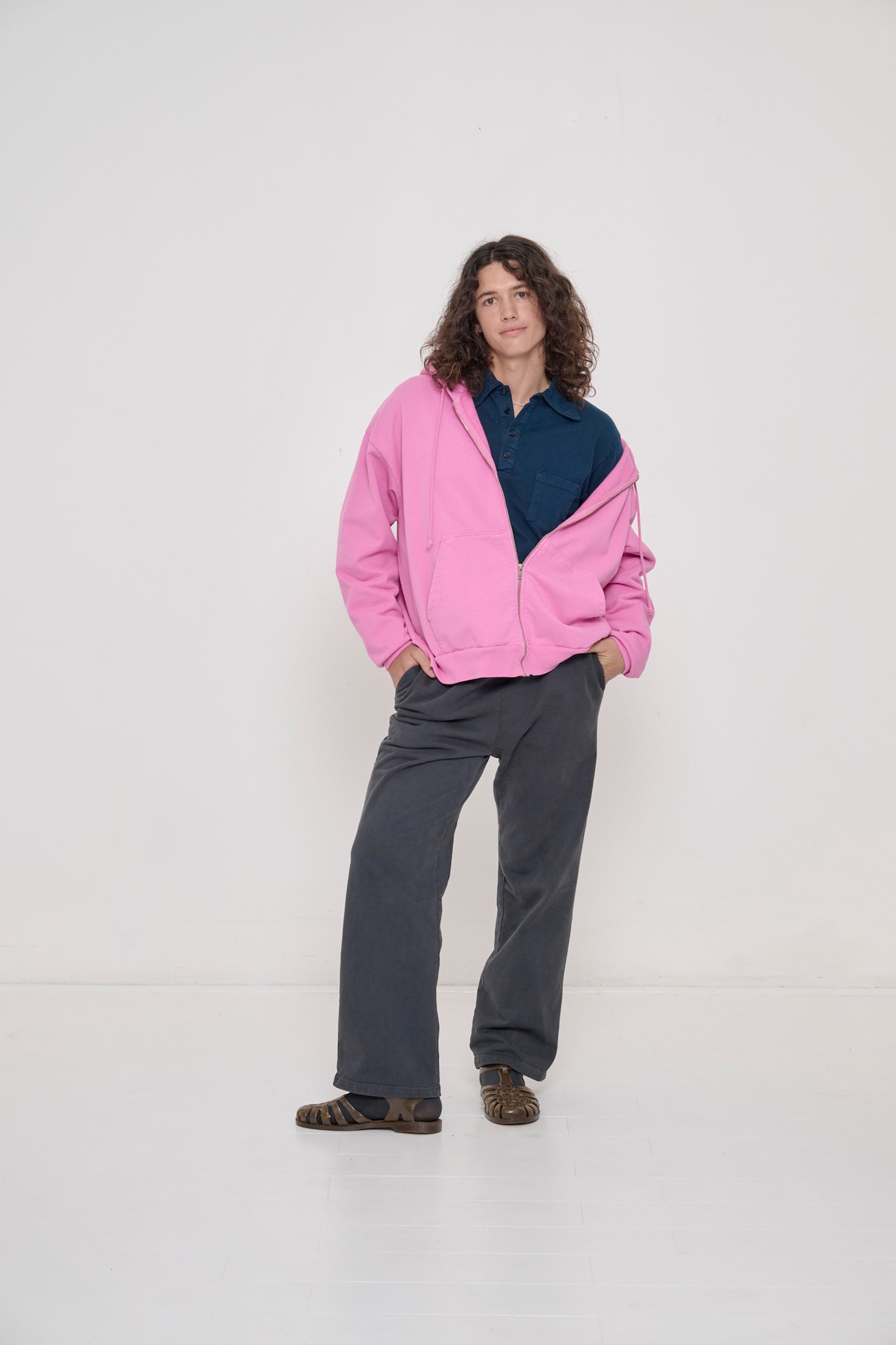 A person wearing Trash Fleece Apartment Pants in Slate and Pixie Trash Zip Up Hoodie.
